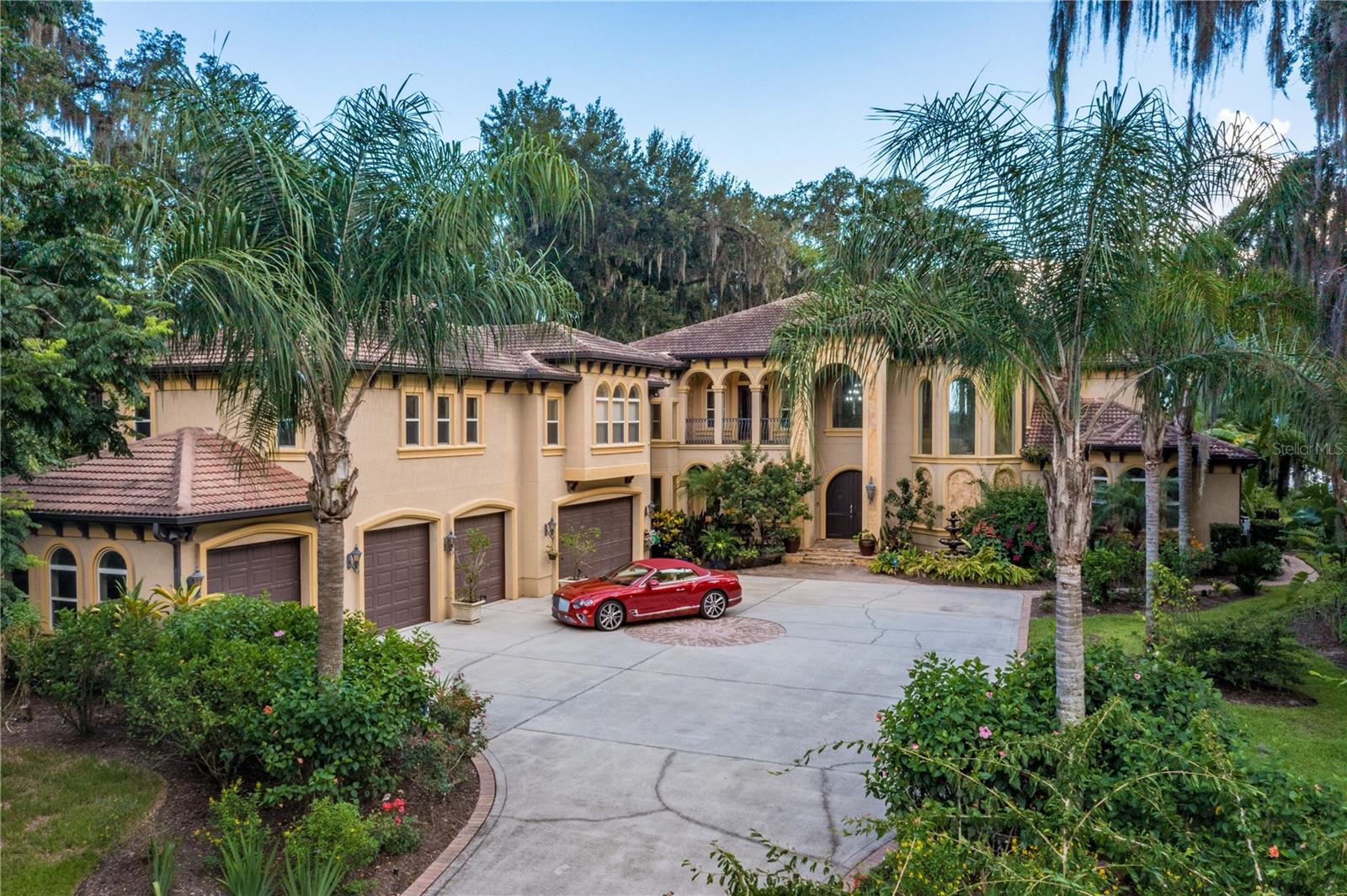 Mediterranean Luxury Riverfront Estate, a private gated St Johns River Estate built on 1.43 acres is a slice of paradise offering resort style amenities designed for entertaining. Custom built to perfection spanning over 6268 sqft 5-bedroom, 8 bath estate expresses the ultimate in Florida outdoor luxury living experience. The main house layout starts with a 2 story grand entry and a sweeping custom designed iron staircase, second story interior balcony, wine cellar, gourmet chefs kitchen, large billiard & theater room and 1st floor owners retreat overlooking resort pool with river views. In addition to the main house, you will find a separate caretakers quarters/guest cottage with 3bedrooms/2baths for privacy. This stunning estate includes 7 car garage & 25x50 AC and heated work garage.
Enter through the 6x8 solid French wood door into a stunning 6,268 Sqft Mediterranean home. You are greeted by the great room that features a gas & wood fireplace with custom bookcases and stunning 22ft 2 steps knock down custom coffered wood ceilings. The exquisite gourmet chef's kitchen features stainless steel appliances, a Samsung double door refrigerator, a large breakfast bar with custom cabinets and a large walk-in pantry. The open dining room features great views, with a built-in butler's pantry/bar with cabinet lighting. Open the French doors which lead you to a 57' Veranda overlooking the pool and riverfront. The private owners retreat boasts 10' ceilings with hand painted murals, a large gas fireplace, California Berber carpeting, custom silk window treatments and beautiful French doors leading out to lanai. The owners bath greats you with imported Italian Stones, Italian granite, and custom workmanship. Relax in the steam dual rain shower. Take the wrought iron spiral staircase which leads you to the atrium with wood floors & 10' dome. As you enter the carpeted theatre room you are welcomed with 7 surround sound speakers with dark ceilings and black out drapes, perfect for a movie night. The billiard room showcases hardwood floors, with a gas fireplace, custom bookcases, and a wet bar that features granite countertops with built in cabinets.
This Spectacular Waterfront Estate Lot features 107ft Bulkhead WF with St. Johns River views. Enjoy a tin roof boat house with a deep-water dock. The salt water heated pool features water purification/self-cleaning filtration. The pool is surrounded with Italian Stone, custom walk-in waterfall, spa, swim up bar, and a 4' beach island. This home has a tropical landscape with outdoor lighting, gated grand entryway, a wrought iron fence, and a sprinkler system. Relax at the summer kitchen or by the outdoor fireplace. An outside cabana bath features storage and an outdoor lounge area. Enjoy your 3BR|2B 1250Sqft guest cottage, with a living room, kitchen, and private parking. Find your oasis at this private protected cove home.