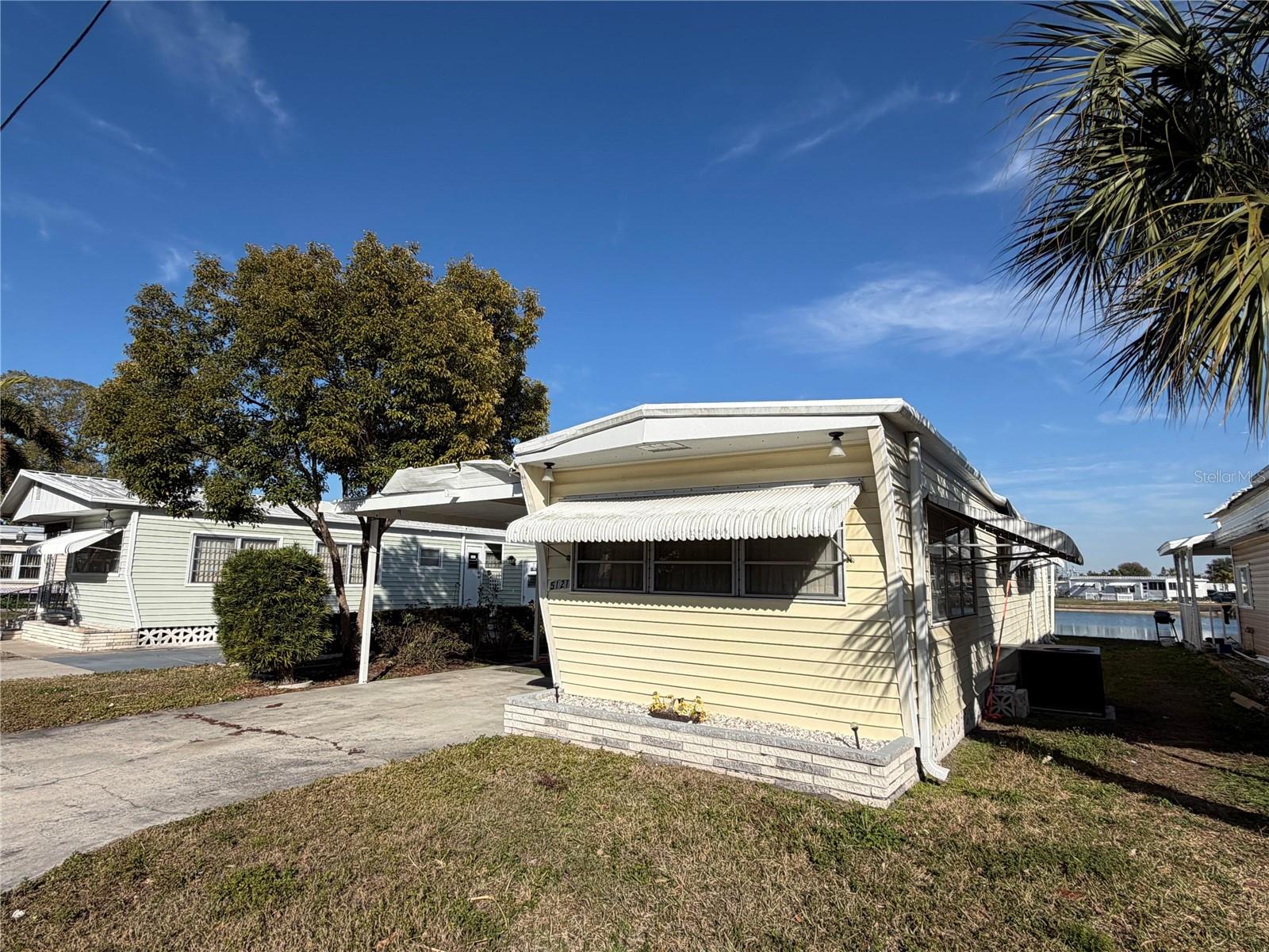 Welcome Home to Your Land-Owned Lakefront Bradenton Retreat on 9th St W
You own the land!
Step inside and feel it immediately — that rare sense of this is the one.

But first, look out back. This 2-bedroom, 2-bathroom mobile home sits directly on the lake, offering the kind of stunning, unobstructed water views that most people pay a premium for. 

Imagine sipping your morning coffee as sunlight dances across the water. Imagine unwinding every evening to a lakeside sunset that never gets old. This isn't a glimpse of the lake. This is front-row living.

The open-concept living area floods with natural Florida sunshine, creating a bright, airy atmosphere that frames those gorgeous lake views from inside your own home. The kitchen is thoughtfully designed for real life — whether you're brewing your first cup of coffee or hosting neighbors for a home-cooked dinner with a waterfront backdrop.

And then there's the additional Florida room — your wildcard space that most buyers only dream about. Use it as a sunlit home office, an artist's studio, a playroom, a reading lounge, or an entertainment den. This is the room that turns a house into your house.

Two full bathrooms mean no more waiting, no more compromising — just effortless daily routines for you and your household.

Priced to sell — the roof sustained hurricane damage and is reflected in the asking price, giving the right buyer a rare opportunity to step in, add instant equity with a replacement, and own a lakefront home in one of Bradenton's most convenient locations for a fraction of the typical cost.

Step outside and you're minutes from waterfront dining, Gulf beaches, lush parks, shopping, and healthcare — all while coming home every night to your own private lake view.
This isn't just a place to live. It's a lifestyle most people only scroll past and wish for — lake views, Florida living, and a location that puts everything within reach.

For the investor or savvy buyer who sees potential where others see a project — a lakefront property at this price point is the kind of opportunity that doesn't come twice.