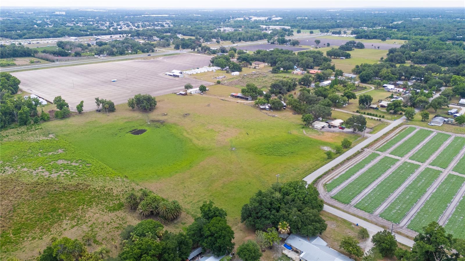 Country charm, wide open skies, and room to build the lifestyle you’ve been dreaming about. Spanning over 13.5 acres in Plant City, this rare property offers TWO homes, a massive 100x24 barn, and endless possibilities for multi-generational living, income potential, or creating your own private ranch retreat.

As you enter the property, you’re welcomed by a charming 2-bedroom, 1-bath country cottage full of warmth and farmhouse character. Tucked farther back on the land sits a double wide mobile home currently being used for storage with future potential for guest quarters, rental income, or additional living space.

The impressive 100x24 barn is ready for equipment, animals, hobbies, storage, or all the toys that come with country living. Bring the horses, cows, chickens, goats, trailers, RVs, and side-by-sides because this property was made for wide open living. From quiet mornings on the porch to sunsets over the pasture, this is the kind of place that feels like your own private escape from the busy world.

Peacefully tucked away while still conveniently located near I-4, shopping, dining, and Downtown Plant City, this property offers the perfect blend of country living and everyday convenience. Opportunities like this are becoming harder to find.