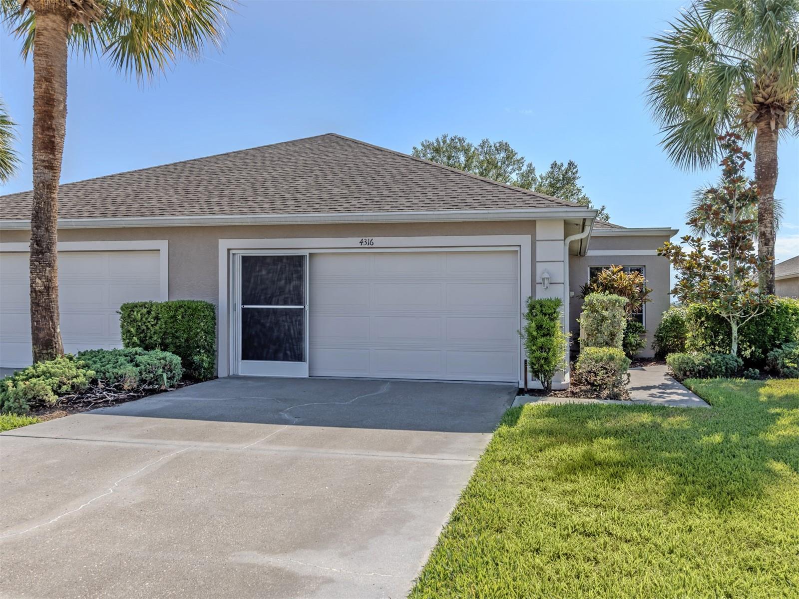 Beautiful 3-bedroom, 2-bath villa with lake view and 2-car garage located in the highly desirable gated community of Villas of Sabal Trace in North Port. This maintenance-free home features a newer roof (2021) and new vinyl flooring, along with a spacious open floor plan and high ceilings that create a bright, airy feel. The generous primary suite offers dual closets and a private bath with dual sinks. A nicely sized second bedroom and full guest bath provide comfort for family or visitors, while the true third bedroom with closet is perfect for guests or a work-from-home office. The kitchen includes ample cabinetry and a built-in desk area, ideal for organization and functionality. Additional highlights include an inside laundry room, extra storage space, and a vinyl enclosed tiled lanai/sunroom - perfect for relaxing year-round. Enjoy low-maintenance living with low HOA fees in a beautifully maintained gated community. Conveniently located near US Route 41 and Interstate 75 in Florida, with easy access to dining, shopping, parks, golf, and area beaches. Just a short drive to Wellen Park in North Port, Charlotte Harbor and Punta Gorda, known for world-class fishing, boating, and waterfront charm.