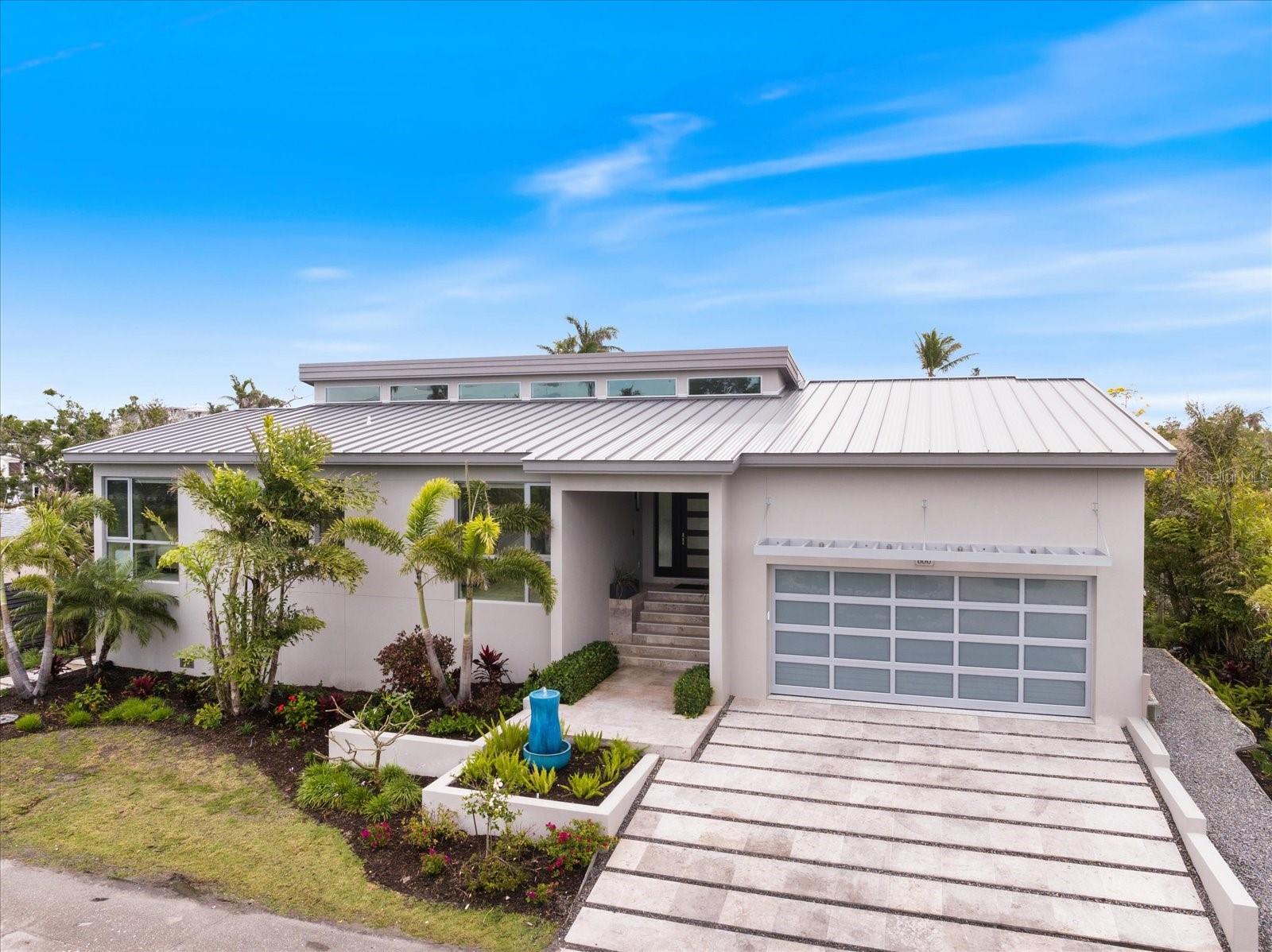 Under contract-accepting backup offers. The Future of Luxury Living on Longboat Key! Discover this newly constructed coastal retreat that sets the standard for modern waterfront living. Located on the private north end of Longboat Key, this turnkey-furnished residence is a sanctuary of style & elegance. Soaring 16-foot driftwood ceilings create an atmosphere of warmth and grandeur, while large impact glass sliders connect you seamlessly between indoor and outdoor living. From the porcelain tiles, custom cabinetry, quartzite countertops in the kitchen to the Italian glass vanities in every bathroom, this home has been constructed with every detail in mind. Enjoy customizable Lutron lighting, automatic shades, built in surround sound system, and a Brinks alarm system with CCTV cameras to protect it all. Looking outdoors, a fire pit, outdoor grill, luxury pool & spa with a waterfall, newly installed dock & 10,000 lb boat lift await you. Built to withstand the elements, this flood-resistant home remains untouched by storms & was powered throughout the storms with it's own generator, offering peace of mind and unmatched durability. Experience the perfect fusion of luxury, privacy, and coastal charm—schedule your private tour today.