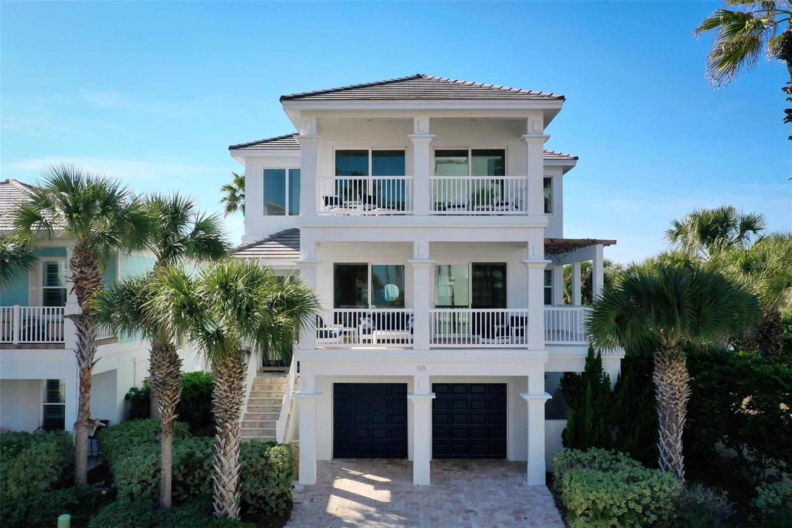 Experience coastal luxury at its finest in this beautifully renovated beachside residence located at 501 Cinnamon Beach Lane in the highly sought-after community of Cinnamon Beach community at Ocean Hammock. Ideally positioned directly across from the beach walkover and just steps from the community's resort-style amenities, this exceptional six-bedroom, five-and-a-half-bath home offers the ultimate blend of modern elegance, functionality, and relaxed coastal living. Extensively remodeled in 2025, the home showcases sophisticated finishes and thoughtfully designed living spaces across three levels, all connected by a private elevator. The stunning renovated kitchen serves as the heart of the home, featuring custom white cabinetry, quartz countertops, stainless steel appliances, a striking coastal-inspired tile backsplash, and an expansive island perfect for gathering and entertaining. Open-concept living and dining areas are filled with natural light and seamlessly extend to outdoor living spaces, including a front balcony with ocean views and refreshing sea breezes. Designed to comfortably accommodate family and guests, the home offers six spacious bedrooms. The second floor includes a guest suite with a king bed and full bath, while the third-floor retreat features the luxurious primary suite complete with a private balcony, spa-inspired bath with soaking tub, walk-in shower, dual vanities, and peaceful views accompanied by the sounds of the Atlantic Ocean. Three additional guest bedrooms are also located on the upper level, creating a dedicated private retreat for family and visitors. A sixth bedroom on the first floor provides additional flexibility and privacy. The first level is designed for entertainment and relaxation, featuring a spacious recreation area with a wet bar and beverage refrigerator, and direct access to the backyard oasis. Outside, enjoy your own private tropical retreat with a heated resort-style pool and spa surrounded by lush landscaping and expansive paver decking. An outdoor shower, multiple balconies, and generous outdoor living spaces further enhance the home's coastal appeal. Residents of Cinnamon Beach enjoy exclusive access to exceptional amenities, including oceanfront and lakeside pools, a fitness center, game room, seasonal café, private beach access, and miles of pristine Atlantic coastline. Whether you're seeking a primary residence, luxury vacation home, or exceptional rental property, this turnkey coastal retreat delivers an unparalleled Florida lifestyle in one of Palm Coast's premier oceanfront communities. Excellent rental history through Cinnamon Beach Vacations! Don't delay!