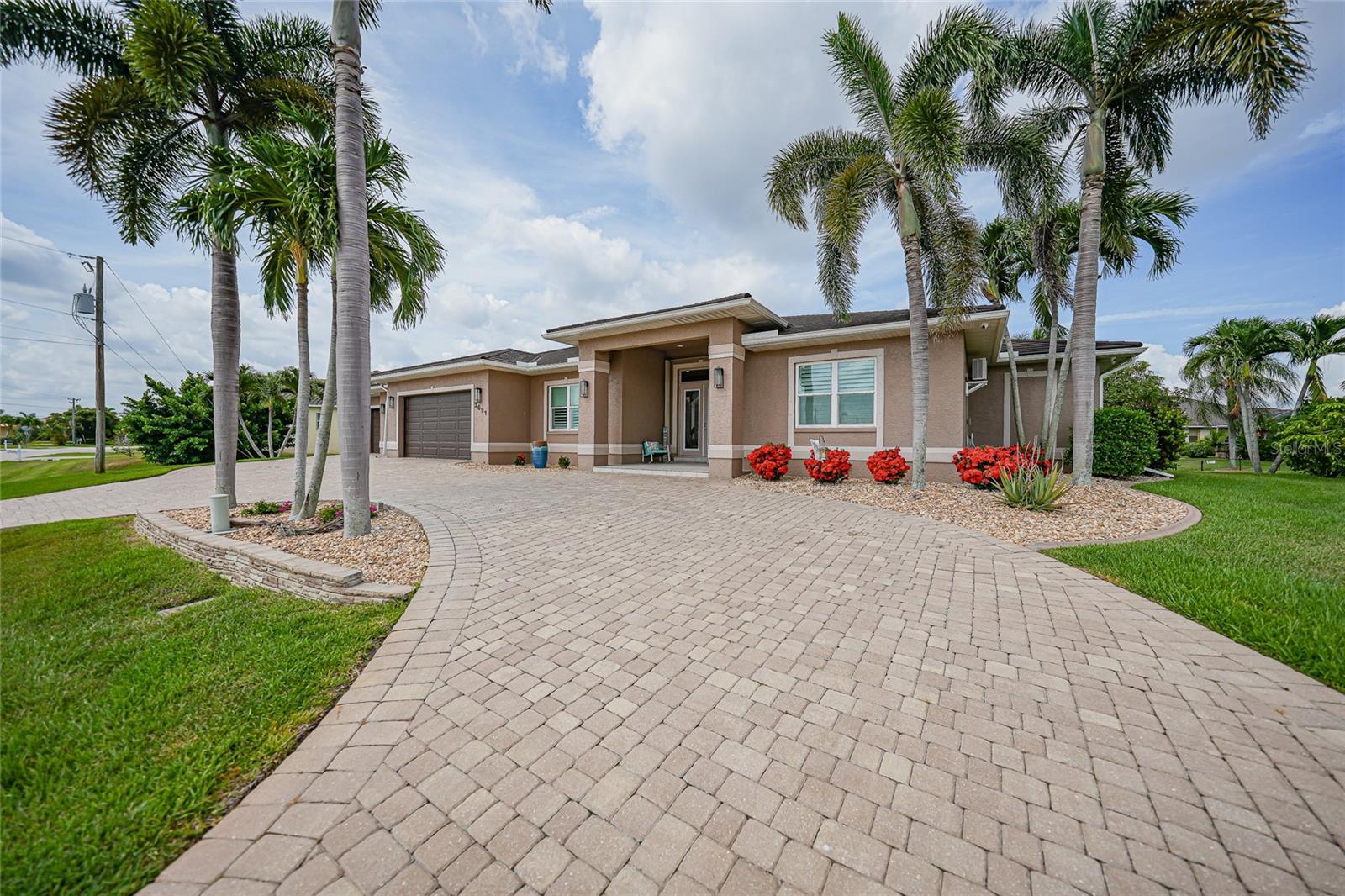 Virtually Staged. Office only. PUNTA GORDA ISLES WATERFRONT RETREAT--This AMAZING LONG CANAL VIEW comes with a DOUBLE LOT, A custom-built 4-BEDROOM, 4-FULL BATHS, 4-CAR GARAGE...YES, 4 cars! home, with 113 FEET of city-maintained CONCRETE SEAWALL, a 70 FOOT CONCRETE DOCK, with sailboat access to Charlotte Harbor and the Gulf, no bridges, approximately 20 minutes to Harbor. This exceptional property is a boater's and car enthusiast's dream! 
This expansive home offers 3,194 SQ.FT. of living area with stunning canal views from nearly every room. The open-concept floor plan features soaring ceilings, abundant natural light, and disappearing sliding glass doors that create a seamless connection between indoor and outdoor spaces. 
The expansive gourmet kitchen was professionally remodeled in 2014 and designed for both everyday living and entertaining. Features include rich wood cabinetry with abundant storage, center island with prep sink, granite countertops, iridescent mosaic tile backsplash, and dual sinks for added convenience. High-end stainless steel appliances includes two refrigerators, built in double ovens, microwave, cooktop with s/s vent hood, wine refrigerator, pot filler, reverse osmosis system, and a spacious walk-in pantry. A separate Butler’s pantry with custom shelving and a lighted liquor pantry provide exceptional organization and storage. The breakfast bar offers additional seating and the generous countertop workspace makes meal preparation effortless.
The adjacent dining areas provide the perfect setting for entertaining while enjoying picturesque waterfront views.
A mini split was added to the Primary Suite which was remodeled in 2014. It serves as a relaxing retreat with direct lanai access, beautiful water views, and a spacious California-style walk in closet and an en-suite primary bath with dual sinks, a jetted soaking tub and a separate spacious walk in shower.
The split room floor plan offers privacy and comfortable accommodations for family and visitors with three generously sized bedrooms, one currently being used as an office. Step outside to your own tropical paradise. The expansive screened lanai features brick paver decking, a HEATED POOL AND SPA that was resurfaced in 2022. The 4th full bath with shower is located on the Lanai-perfect for cleaning up after a day out on the boat. Boating enthusiasts will appreciate the 70-foot concrete dock, with two boat lifts, including a 20,000-pound lift and a slide Moor Lift. The DOCK is equipped with water and electric on a marine pedestal with two 30-amp, and one 50-amp outlet. Approximately 20 minutes to open water through Buckley’s Pass. Whether heading out for a day of fishing, cruising Charlotte Harbor, or exploring the Gulf waters, this property's location offers exceptional convenience and access.
Additional features include a NEW METAL ROOF (2024), FULLY PAID/owned SOLAR PANELS-for reduced electric bills which are less than $50 per month!, central vacuum, brick paver circular driveway, 2 mango and avocado trees. The oversized 4-car garage has EPOXY FLOORING, large workshop space, and it also has a mini split keeping it cool during the summers. Plenty of room for vehicles, tools, hobbies, and storage. TWO A/C UNITS-with UV lighting filtration, and a 400 amp electrical system. Combining luxury, functionality, and an unparalleled boating lifestyle, this exceptional Punta Gorda Isles waterfront home offers a rare opportunity to enjoy the very best of coastal Florida living.