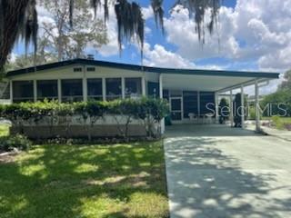 Time to make an offer, been on market too long, seller wants sold. Spacious property with much to offer, such as the burnable fireplace. Partly furnished allows you to move forward and start living the Florida lifestyle of enjoyment. So much to do in our community, activities galore if you want to attend or just relax pool side, if your the energizer bunny, we have a bunch that live here and its hard to keep up. The rooms are larger with large additional space on side which includes screened Florida room with workshop, laundry area and large area for 2 golf carts, one is included but needs new batteries. The yard is landscaped so you can enjoy the tropical setting. Short distance to golf course, pool, restaurant and when you want a change of scenery, 3 miles to Brownwood in The Villages where you will find nightly entertainment, more restaurants and shopping. We're central Florida, 35 min. north to Ocala, 1 hr south to Orlando, and 1 hr. east or west to the beaches. You will love it here, I know because I live here and love it.