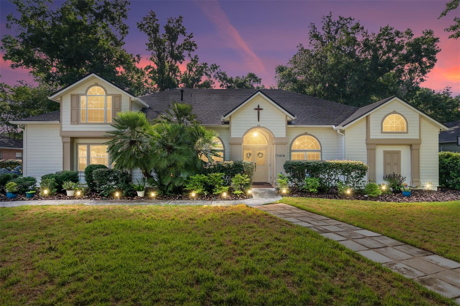 Located in the heart of Gainesville at 7513 NW 50th St, you will find this stunning spacious, high ceiling, desirable split bedroom plan, updated, moved-in ready turnkey 5-bedroom, 2+2-bathroom pool home nestled in Blues Creek, just minutes from San Felasco Hammock Preserve State Park, Devil’s Millhopper Geological State Park, walking trails, wildlife, green spaces but still conveniently close to shopping at Publix at Hunter's Crossing Shopping Center. With 2,700+ square feet of beautifully updated living space, this property is ready to impress.
Step inside the tiled entryway foyer to discover the formal dining and living area. Enjoy the eat-in kitchen featuring custom birch cabinets, large island, all stainless steel appliances, gas range, convection oven, Bosch dishwasher, new double door fridge, 3 pantries and a breakfast bar. The spacious 18ft ceilings living room provides natural light and comes with a stone gas fireplace. Downstairs, all 4 bedrooms offer clean,
modern Acacia wood flooring perfect for any lifestyle. The 2 bedrooms are adjoined by an updated Jack-and-Jill full bathroom with a brand-new shower. The primary bedroom is your dream retreat with custom frosted glass door leading to an ensuite bath and shower and custom walk in closet. The primary bedroom also opens to the relaxing waterfall spa pool retreat as you step out onto the paver, screened in patio. Additionally, upstairs, you will find the 5th bedroom with a half bath and closet with upgrades including a new AC unit. Every detail has been thoughtfully refreshed along with fresh new interior paint. Outside, you will truly see how this home shines. The private huge, fully fenced
backyard is an absolute oasis, complete with fire pit, two sheds, a greenhouse with electricity, a screened in heated saltwater pool and spa with waterfall that invites year-round relaxation and entertainment. A newly installed whole-home generator provides peace of mind during Florida's unpredictable weather. The front lawn has been completely redone and raised with fresh sod, complemented by a brand-new driveway and updated sidewalks along the back of the home. Updated with beautiful new landscaping, and the updated irrigation system keeps everything lush and green. Trees were professionally removed to open up the property and let natural light pour in. The fresh exterior paint ties everything together, giving this home incredible curb appeal from every angle. Walk a few steps down from your home to take full advantage of all the community has to offer: pool, tennis courts, and clubhouse. This move-in-ready gem offers peace, comfort, style, convenience and oasis resort-like outdoor living in one of Gainesville's most desirable locations. Schedule your private showing today before this one is gone!