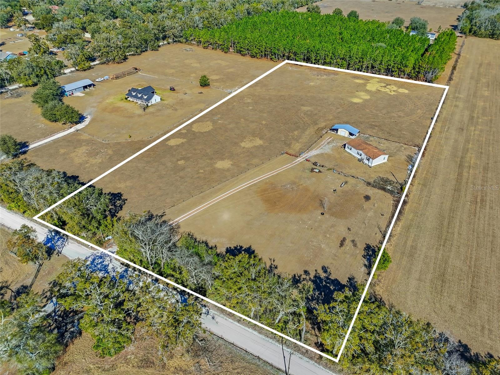 Nestled on over 8 acres with a private drive, this spacious 1,900+ square foot home in Bell offers the perfect blend of privacy, room to roam, and comfortable country living. The well-maintained, thoughtfully designed 3-bedroom, 2-bath split floor plan provides excellent functionality and flow, with generously sized rooms throughout. The chef-inspired kitchen is a standout feature, boasting a gas convection oven, electric stove, abundant cabinetry, a large center island with additional storage, and a sink that overlooks the peaceful backyard. The master suite is a true retreat, featuring a well-appointed bathroom with dual vanities and a relaxing Jacuzzi tub. Step outside to the expansive back deck—ideal for entertaining, unwinding, or simply taking in the serene surroundings. The property is fully fenced, and with no HOA or deed restrictions, you’ll have the freedom to bring your animals and fully embrace the rural lifestyle. Additional highlights include a 30x40 metal carport and a desirable Gilchrist County location. Just minutes from the famous Suwannee River, this property offers easy access to boating, fishing, and outdoor recreation. Conveniently located only 30 minutes from downtown High Springs, 45 minutes from Gainesville, and 55 minutes from Steinhatchee—making it an ideal retreat for those seeking space, privacy, and the best of rural Florida living.