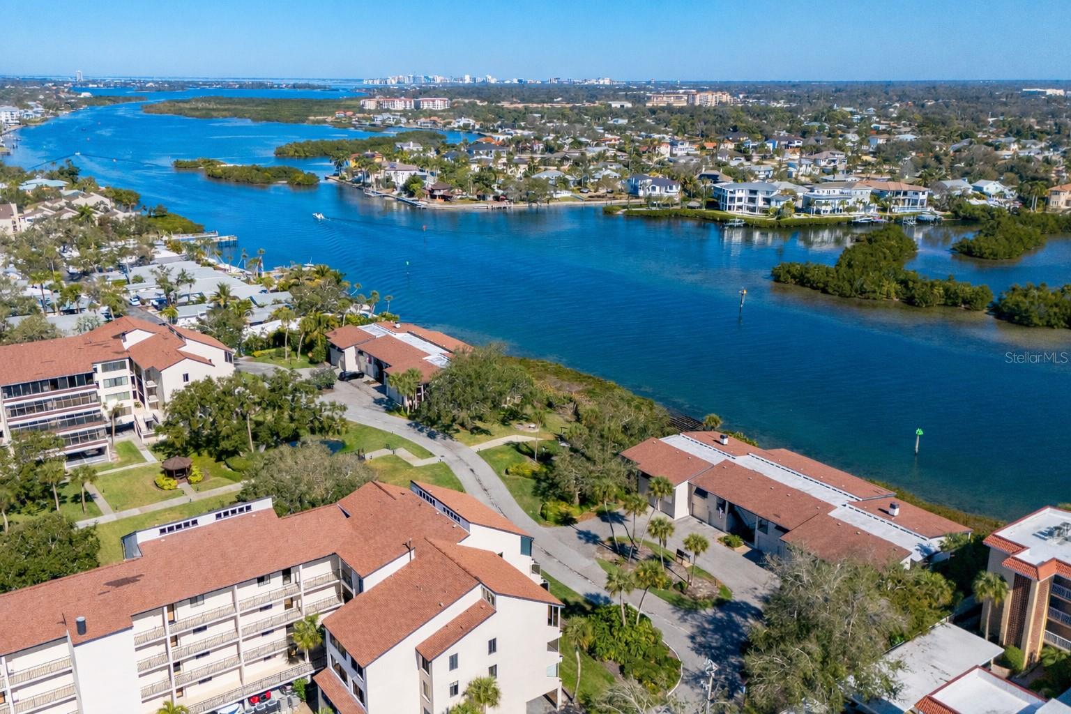 New price - $100K less! Offered for the first time, this rare three-bedroom, three-bath waterfront villa at Excelsior’s coveted Beach-to-Bay community presents an exceptional opportunity to own one of only eight residences of its kind. Positioned on Sarasota Bay and the Intracoastal Waterway, the villa enjoys extraordinary privacy, peacefulness, and sweeping 180-degree water views from the expansive 36-foot lanai and most principal rooms. This light-filled corner residence lives beautifully like a single-family home, elevated above a private two-car garage and framed by windows on three sides. The open floor plan is spacious and airy, enhanced by vaulted ceilings in the living room, primary suite, and guest bedroom, hardwood flooring, and sliding glass doors that invite the waterfront setting indoors. A wood-burning fireplace adds warmth and character, while ceiling fans, custom window treatments, and 3M hurricane film on windows provide comfort and peace of mind. The updated kitchen opens seamlessly to the main living areas, creating an ideal space for entertaining or relaxed island living. The primary suite features a walk-in closet, a walk-in shower, and an updated bath. A new HVAC system, in-residence washer and dryer, and thoughtful upgrades throughout add to the villa’s move-in-ready appeal. Excelsior’s villas are uniquely situated directly on Sarasota Bay’s Intracoastal Waterway, with no other residences between you and the water. Only eight villas exist in total, four three-bedroom residences and four two-bedroom villas, making this a limited opportunity. Residents of Excelsior enjoy an unparalleled resort lifestyle with deeded beach access to Siesta Key’s world-renowned white sands, turquoise Gulf waters, and mango-colored sunsets. Amenities include two large, heated pools, two hot tubs, tennis and pickleball courts, shuffleboard, a fitness center, a library, a community room, and tranquil, tree-lined walkways with ponds and fountains. The fishing and lounging pier, grilling areas and picnic spaces are just moments away. The community is pet-friendly (small dogs), offers easy access to South Bridge and a short distance to Crescent Village, with free trolley service to Siesta Village. With a two-week minimum rental policy and on-site property management services available, the residence also offers attractive flexibility for seasonal or investment use. From morning experiences along the shoreline to breathtaking sunsets over the Gulf, every day on Siesta Key feels like a vacation. And when you're ready to explore beyond the island, downtown Sarasota is just a short drive away, offering world-class dining, arts and culture, including the Ringling Museum, Van Wezel Performing Arts Hall, and St. Armands Circle. Rarely available and exceptionally positioned, this waterfront villa captures the best of Siesta Key living, privacy, views, resort amenities and effortless access from beach to bay.