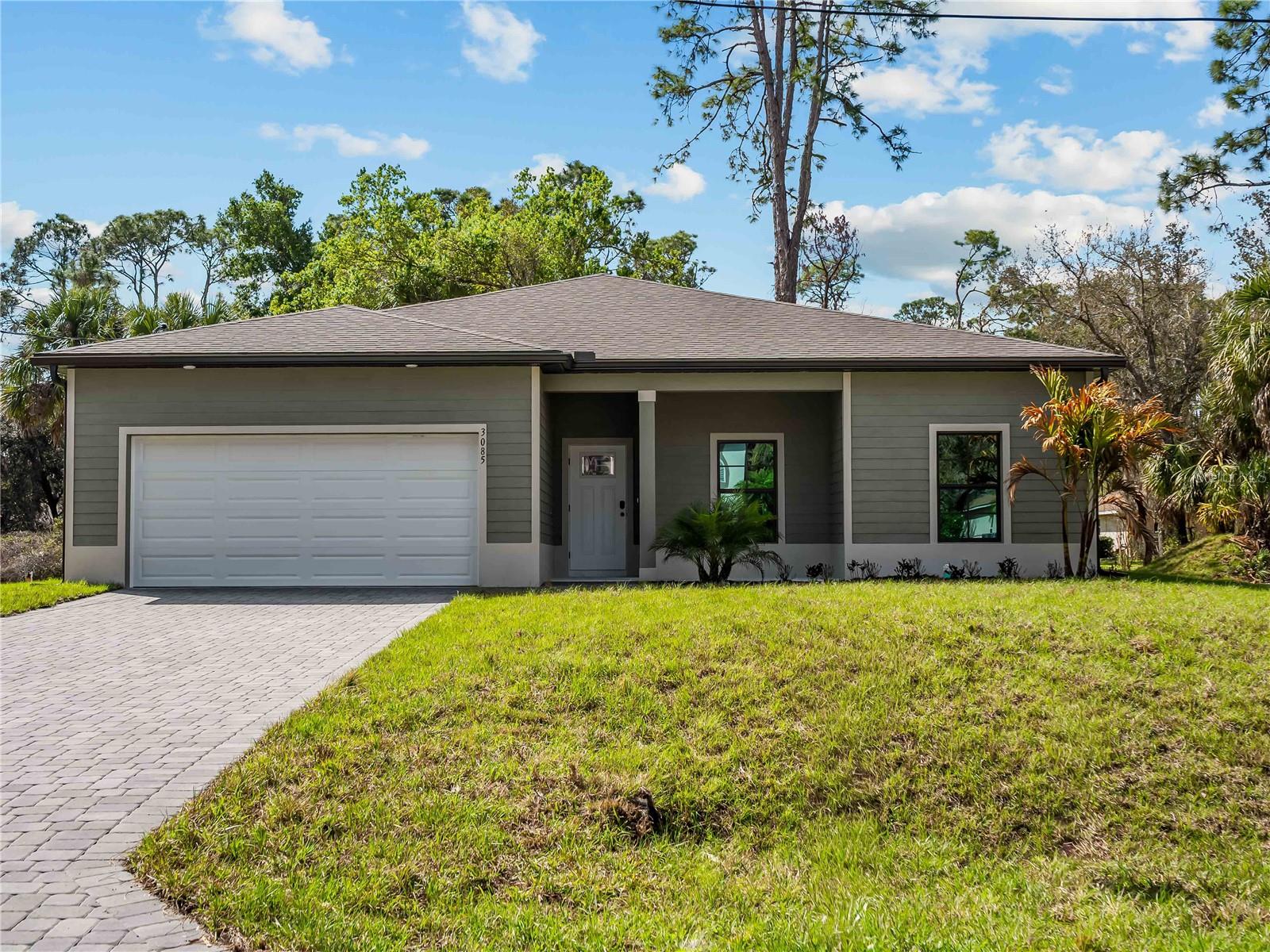 Virtually Staged. Tile throughout. Quartz countertops. Impact windows. Paver driveway. Whole-house generator plug. Fully upgraded new construction in North Port.

Flood insurance is not required for this property.

The layout is a 4-bedroom, 2-bath split floor plan with 1,710 square feet of living space. When you walk in the front door, the kitchen island is front and center. If you love an open kitchen that's the heart of the home, this layout works well for you. The primary suite is separated from the three secondary bedrooms, giving you flexibility for guests, a home office, or whatever you need the space to be.
No carpet anywhere. No vinyl. Tile throughout every room.

Impact-resistant windows are already in. The paver driveway is already in. The whole-house generator plug is already in. The builder did not cut corners on this one.

Buyers may be eligible for up to $5,000 in flex cash that can be applied toward closing costs or a rate buy-down.
Backed by a 2-10 Builder's Warranty.

Some photos are of the same floor plan and may not reflect current fixtures or colors in this home.