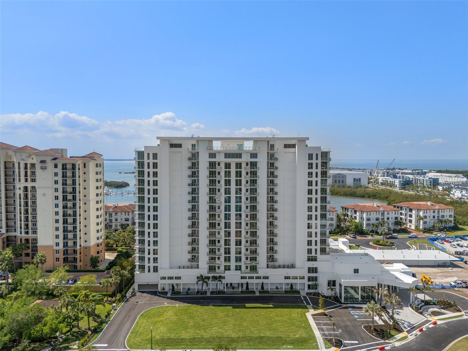 Virtually Staged. Experience elevated waterfront living from AQUA at Westshore Yacht Club, South Tampa’s newest residential tower. This brand new, exceptional three-bedroom, plus den, three-and-a-half-bath residence showcases sweeping, unobstructed views of Old Tampa Bay, where breathtaking sunrises paint the sunset and sparkling water vistas create a spectacular backdrop throughout the day. Ideally positioned to capture the beauty of the bay from nearly every angle, this residence offers an extraordinary blend of luxury, comfort and convenience, starting with a private elevator foyer. Greeted with a double-door entry, the spacious floor plan features expansive windows and sliding glass doors that flood the home with natural light while the generous living and dining areas flow seamlessly together, creating an inviting atmosphere for gatherings large and small. The kitchen is thoughtfully appointed with Sub-Zero and Wolf appliances, Italkraft cabinetry and a stunning quartz waterfall countertop to complement it all. The generous owner's suite features two walk-in closets and a spa-inspired bath with a freestanding soaking tub, an oversized walk-in shower, dual vanities and a private water closet. This unit comes equipped with two side-by-side parking spaces. Standing 17 floors, AQUA pairs sunset water views with sunrise city skylines. The amenity package is exceptional: a rooftop sky pool with private cabanas, a third-floor pool and spa with grilling and lounge areas, an elegant club room with a sports lounge and billiards, a private dining room, a golf simulator, a theater, a playroom, private offices and two furnished guest suites. A 17th-floor bayfront fitness center includes dedicated yoga and spin rooms and every residence has climate-controlled storage on its own level. Arriving guests are welcomed by valet beneath the covered porte-cochère, leading to a lobby with a signature ceremonial staircase rising to a second-floor library lounge. A 24/7 staffed lobby, on-site management and service personnel ensure an effortless lifestyle. Westshore Yacht Club is South Tampa's premier gated waterfront community, home to the members-only Bay Club and a 175-slip marina, two resort-style pools, the 806 Sunset Bar and Tiki Bar, indoor fine dining, a day spa, a fitness center, and community and dog parks.