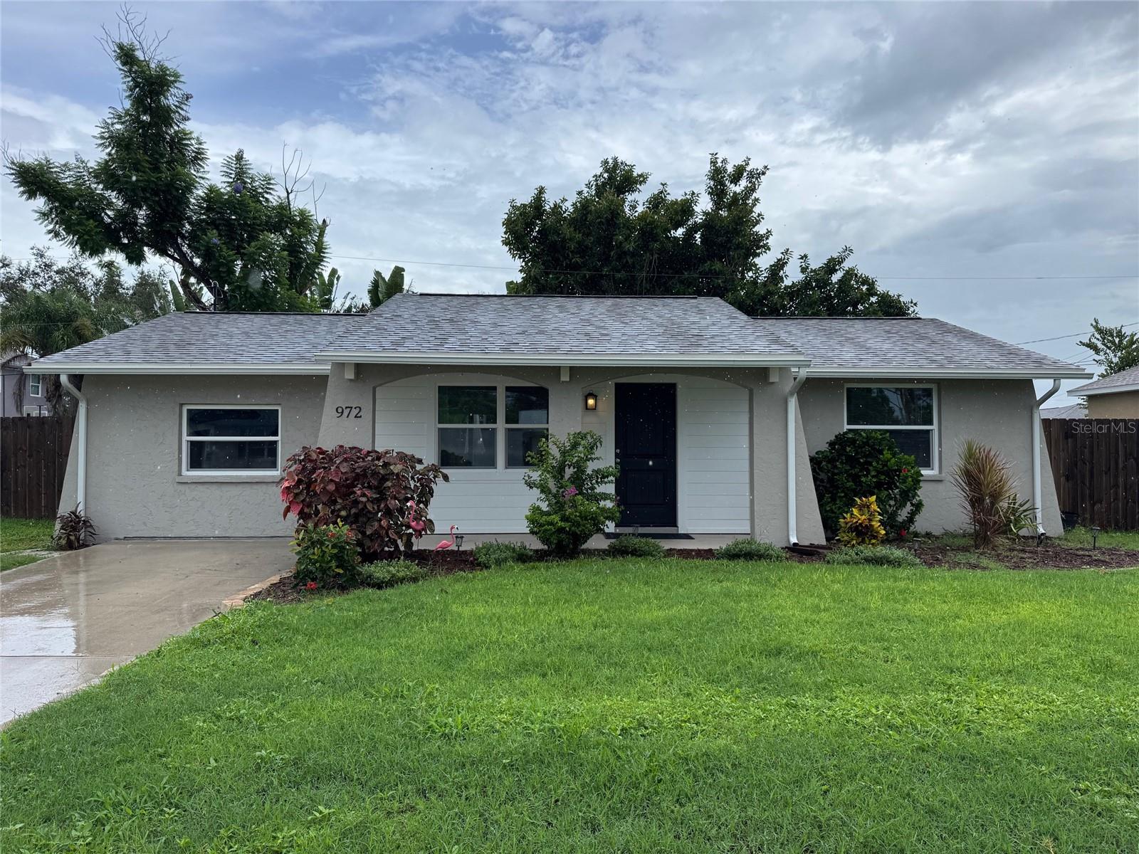 REDUCED PRICE & MOVE IN READY HOME! This Home and property had been remodeled with fresh paint inside and out, fixtures, vinyl flooring throughout, kitchen cabinets, quartz counters, backsplash and all stainless steel appliances, bathrooms with redone showers and toilets, vanities, water heater and ROOF all in 2023 and recently has since been enhanced by Adding all Hurricane Windows (except rear door), removing overgrown trees, enclosing the garage to make a bonus room, added a gravel parking area for RV, TRAILER, BOAT or just visitor parking, shed and double gate into a fenced yard. Enjoy the neighborhood and close proximity to beaches, restaurants, shopping and entertainment. Priced to sell. COME SEE IT BEFORE IT IS GONE!