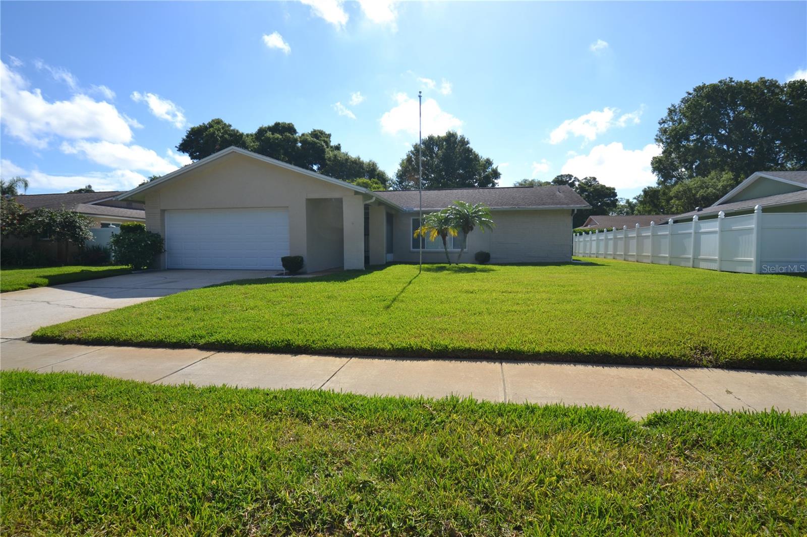 Call to see this wonderful 2-bedroom, 2-bath home that is move-in ready and perfect for enjoying the Florida lifestyle. Just in time for the 4th of July, this beautifully maintained home offers a desirable split-bedroom floor plan with spacious rooms and plenty of living space. The primary suite is large enough for a king-size bed and features a walk-in closet. The guest bedroom is also generously sized and located on the opposite side of the home for added privacy. The spacious living and dining area is ideal for relaxing or entertaining, while the kitchen includes a cozy breakfast area with space for a home office or sitting nook. Step outside to the covered, screened patio enclosure, perfect for enjoying your morning coffee or evening breeze. Lawn care is included and paid for by the owner, giving you more time to enjoy your weekends. Additional features include a 2-car garage and washer and dryer hookups conveniently located inside the home. Situated in a lovely neighborhood close to shopping, dining, and everyday conveniences along Belcher Road, Sunset Point Road, and Main Street. No cats allowed. One small dog may be considered. This exceptionally clean home is ready for its new residents.