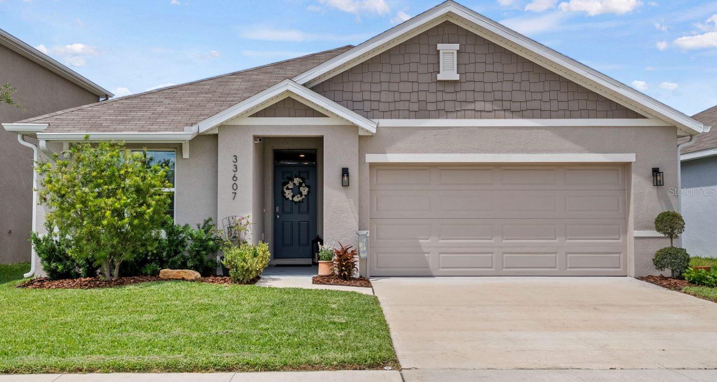 Welcome to Westgate at Avalon Park, where newer construction, thoughtful upgrades, smart-home convenience, and true neighborhood charm come together in one beautifully loved home. PRICED BELOW APPRAISED VALUE, this 3-bedroom, 2-bath, 2-car garage home offers the fresh feel and efficiency of newer construction with the comfort of a home that has already been finished, improved, and cared for. Built in 2023, the home features a bright open layout, stylish upgraded finishes, low electric bills, smart-home technology, and an easy flow designed for everyday living. Enjoy the convenience of controlling your home’s temperature from afar, allowing you to condition your home through an app before you even walk through the door.

The kitchen sits at the heart of the home with granite countertops, stainless steel appliances, beautiful cabinetry, and a seamless connection to the dining and living areas, creating a warm gathering space for meals, conversation, and connection. The split-bedroom floor plan offers privacy and function, while the spacious primary suite provides a peaceful retreat at the end of the day. Outside, the backyard has been thoughtfully enhanced and lovingly enjoyed, offering a spacious setting for weekend cookouts, birthday parties, playtime, pets, gardening, or quiet evenings under the Florida sky.

But Avalon West is where this home truly becomes a lifestyle. This golf-cart-friendly, community-focused neighborhood offers something for everyone, with three pools including a splash pad for kids and a lap pool, pickleball courts, playgrounds, clubhouses, dog parks, fishing ponds, and year-round opportunities to connect with neighbors. Picture yourself joining the 4th of July celebration, entering the apple pie bake-off, enjoying free ice cream day, taking a golf cart ride through the community, or casting a line at the pond after dinner.

Pine Crest Academy is an A-rated charter school located within the community along with other school options, adding convenience for those who value close access to educational options. Just minutes from shopping, dining, entertainment, and major commuter routes, Avalon West offers the feeling of a close-knit neighborhood with the convenience of Wesley Chapel living.

100% Financing Available and no flood insurance is required. Move-in ready, energy efficient, beautifully maintained, smartly equipped, and priced with purpose, this Avalon West home is more than a place to live. It is a place to belong.