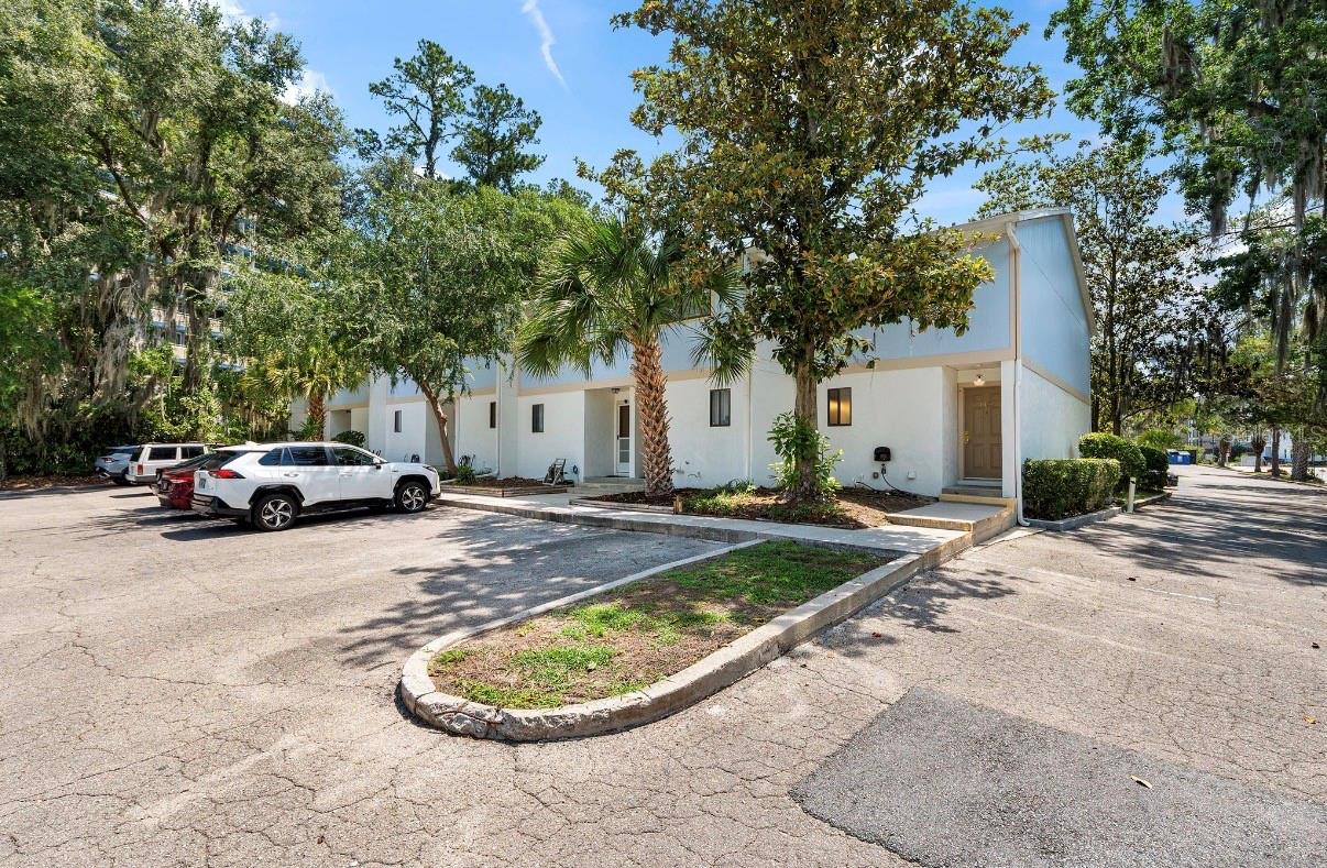 Welcome to Bivens Forest! This spacious end-unit 2-bedroom, 1.5-bath end-unit condo offers a functional two-story floor plan in one of Gainesville’s most convenient locations. Just minutes from UF, Shands, the VA Hospital, Depot Park, and downtown Gainesville, this home combines comfort, convenience, and low-maintenance living. The first floor features a large living room, dining area, half bath, washer/dryer closet, and kitchen with ample cabinet and counter space. A breakfast bar overlooks the living area, while sliding glass doors lead to a covered back patio, an outside storage room, and community green space. Upstairs, you'll find two generously sized bedrooms with ample closet space. One bedroom includes a covered balcony overlooking the community grounds. The Jack-and-Jill style bathroom features separate vanity areas and a central tub/shower combination. The unit includes two assigned parking spaces, with additional guest parking. Residents enjoy access to the community pool and the peaceful atmosphere of this quiet complex. Whether you're looking for a primary residence, a game-day retreat, or an investment opportunity, this condo offers an excellent location close to shopping, dining, entertainment, UF, and major medical facilities.