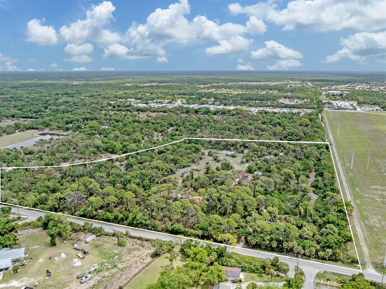 Offering approximately 15 acres in a strategic Venice location, this property presents a rare opportunity for those seeking privacy, space and flexibility. Whether envisioned as the site of a custom estate residence, a live-work environment, or a property with room for recreational vehicles, boats, equipment or other personal storage needs, the expansive acreage provides options that are increasingly difficult to find in the area. The natural Old Florida setting enhances the sense of seclusion while remaining conveniently close to major roadways, healthcare, shopping and daily conveniences. This 15-acre offering is ideally just off East Venice Avenue between Jacaranda Boulevard and River Road. Zoned OUE (Open Use Estate), the property may allow for residential, multi-family or light industrial uses, offering a range of potential development opportunities. Featuring the character and natural setting reminiscent of Old Florida, the property offers a unique opportunity to develop while preserving the charm and landscape that make this area desirable.  A survey is available. This land offering presents a compelling investment opportunity for developers, builders, investors and commercial users seeking to capitalize on the continued expansion of the Venice area. With strong growth, increasing housing demand and expanding commercial infrastructure, the property offers long-term upside potential, development flexibility and strategic positioning within one of the region’s active growth corridors.