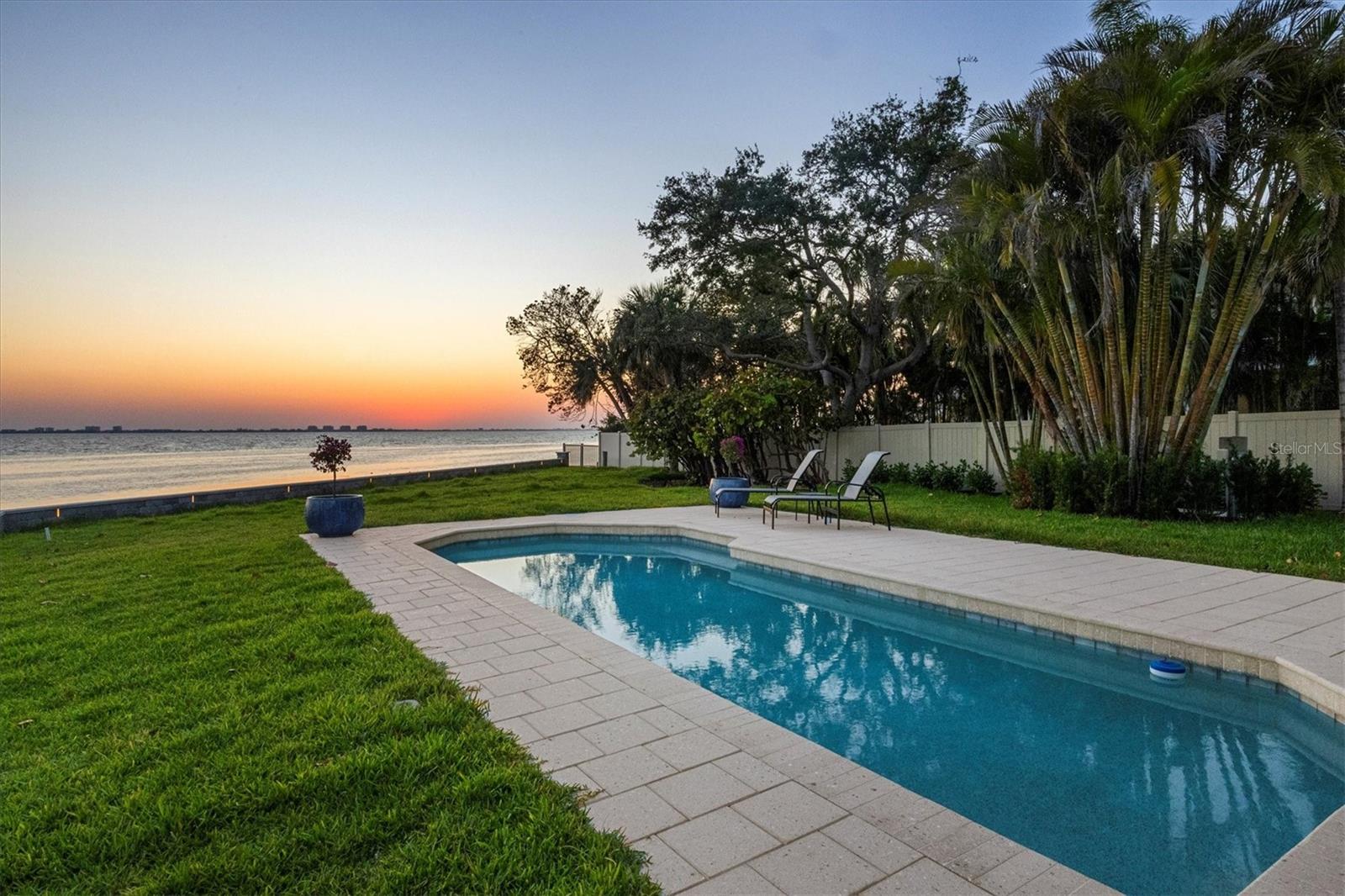 Under contract-accepting backup offers. Virtually Staged. Move-in ready luxury "Beyond the Gates" of Sarasota Bay. Nestled in the historic Indian Beach–Sapphire Shores neighborhood, this single-level bayfront retreat offers 3,000 sq. ft. of refined living space. "Effective Year Built: (2005) per County Tax Records.  Reimagined in 2010 and freshly updated interior and landscaping in 2025, the residence features a metal roof and full impact windows for total peace of mind. The 4-bedroom, 3-bath interior captures amazing sunset views through expansive glass, flowing effortlessly to a private bayfront pool. A rare opportunity for both luxury living and investment potential, this Sarasota Bay waterfront estate allows weekly rentals and is ideally positioned to capitalize on Sarasota's thriving vacation rental market. The combination of direct bay frontage, stunning sunsets, private pool, extensive 2025 renovations, and proximity to downtown Sarasota, Longboat Key, St. Armands Circle, IMG Academy, and SRQ Airport creates broad appeal for seasonal and short-term guests seeking a premier waterfront experience.Enjoy a private sanctuary only 10 minutes from Downtown Sarasota. Potential for ADU and short term rental subject to City of Sarasota regulations.