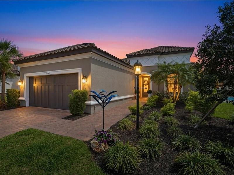.Ideally situated in Bradenton between State Road 70 and University Parkway, this gated neighborhood is just west of I-75 and east of US-301, providing effortless access to the UTC Mall area, local Gulf beaches, and SRQ Airport. From the moment you arrive, the pride of ownership is undeniable. This pristine property has been freshly painted inside and out, blending elegant architectural details with ultimate peace of mind. Complete with full-home hurricane impact windows and doors, this home offers top-tier storm protection and maximum energy efficiency without the hassle of shutters. Step inside to find an expansive open floor plan elevated by grand tray ceilings, elegant crown molding, and custom feature-paneled accent walls. At the heart of the home is a fully upgraded chef’s kitchen, beautifully refreshed with premium finishes, high-end appliances, and ample workspace for effortless hosting. The living space flows seamlessly outdoors to a spectacular, expanded entertainment area designed for the ultimate Florida lifestyle. This private backyard paradise features a professional outdoor kitchen fully equipped for upscale alfresco dining, a pristine heated pool with a brand-new pool heater for year-round enjoyment, and a premium screen enclosure outfitted with a brand-new "no-see-um" mesh cage to ensure pest-free relaxation day or night. New seamless gutters have also been installed around the entire home for superior water management. Owning this Taylor Morrison signature build means enjoying a true resort-style lifestyle where every luxury is included. The vibrant Esplanade community includes an on-site Lifestyle Manager and endless extras: a beautiful luxury clubhouse, a sparkling resort-style pool with cabanas and a hot spa, a state-of-the-art fitness center with a dedicated aerobics studio, specialized spa treatment zones, multi-sport courts for tennis and pickleball, and welcoming indoor/outdoor entertainment gathering spaces. Best of all, this property is fully maintenance-free, offering incredibly low HOA fees and the added financial benefit of being a Homesteaded property with capped real estate taxes. Kept to an absolute showroom standard, this turn-key executive home feels brand new and is ready for its next owner.