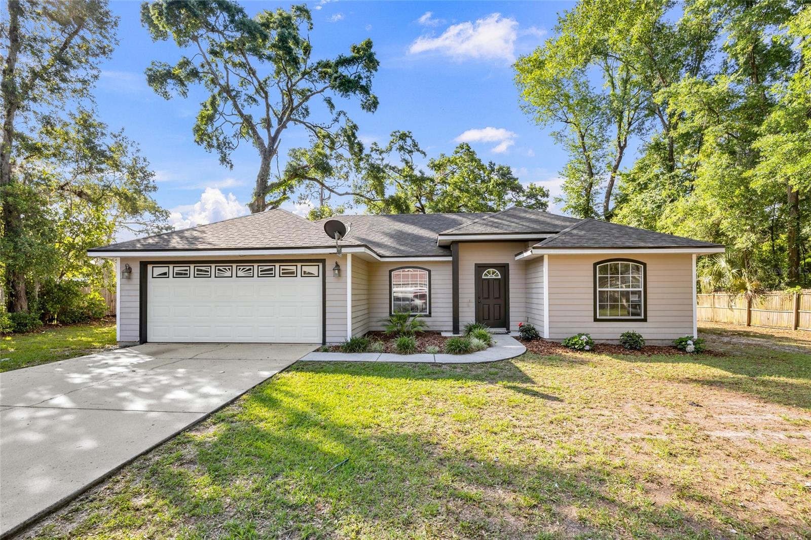 Welcome to this adorable and meticulously maintained 3-bedroom, 2-bathroom home located in the heart of Levy. With a host of new features and a prime location, this property offers the perfect blend of comfort, convenience, and style. Recently installed black shingle roof, 6' privacy fence, new bathroom vanities, exterior paint, kitchen cabinets painted and new kitchen appliances, including a stove, dishwasher, and a charming farmhouse sink. All bedrooms now feature elegant laminate flooring, adding a touch of modern sophistication. The back porch is perfect for relaxing, while the spacious backyard with a full privacy fence is ideal for cookouts and gatherings. Includes a two-car garage and a convenient shed in the backyard for additional storage needs. This home has been lovingly cared for and is move-in ready. No HOA! Enjoy the low tax base of Levy while being just 25 minutes from Gainesville and 35 minutes from Cedar Key. Don't miss your chance to own this charming home with all the modern updates you desire. Schedule a viewing today and see for yourself the comfort and convenience this property has to offer.