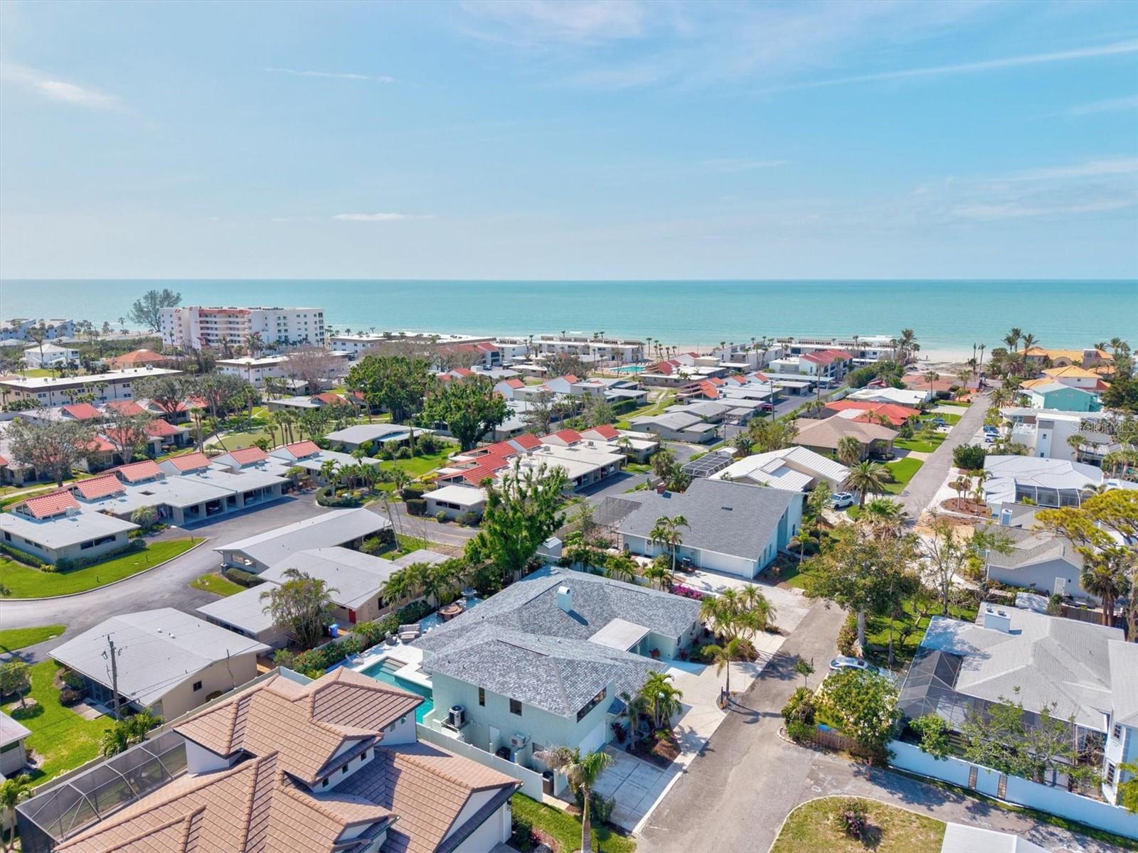 Where else can you find a home of this size, offering this level of quality, only 250 yards from the Gulf of America at this price? Enjoy private,
gated beach access just steps from your front door in this meticulously renovated 6 bedroom, 4 bath island home, being sold FULLY FURNISHED complete with an air conditioned garage, located on the island of Venice only seven homes from the Gulf of America. From the moment you arrive, the curb appeal makes a statement, featuring a freshly painted exterior, manicured landscaping, and a circular driveway. Combined with the attached garage and extended side driveway, there is abundant parking for vehicles, boats, and RVs. This home was unaffected by last year’s hurricanes and is located outside of a flood zone, meaning flood insurance is not required. The backyard is a true private oasis, highlighted by a heated custom pool, a beautiful marble deck, and a fully equipped second kitchen with direct access through sliding glass doors off the pool area.
A majestic banyan tree shades the expansive patio and walkways, creating an ideal setting for large gatherings and outdoor entertaining. Inside, the remodeled kitchen is designed for both beauty and function, featuring stainless steel appliances, upgraded soft close wood cabinetry, granite countertops, and an oversized island that flows seamlessly into the open concept family room and spacious dining area. Just off the double door entry, a second living space provides a warm and inviting retreat, complete with a charming fieldstone fireplace. The secluded primary suite offers exceptional privacy, featuring a large walk in closet and a spa inspired ensuite bathroom with high end finishes. On the opposite side of the home, the main level includes three additional bedrooms, two bathrooms, and a secondary kitchen, perfect for poolside entertaining or multi generational living. Upstairs, two generously sized bedrooms share a remodeled Jack and Jill bathroom, offering flexible space for guests or extended family. This home has been completely transformed with modern upgrades throughout, including new electrical and sewer lines, a new roof, updated air conditioning system, and enhanced pool and deck features. A new irrigation well and irrigation system have also been installed. Whether you are enjoying breathtaking sunsets from your heated pool and patio or taking a short walk to your private beach access, this home captures the essence of Florida island living. Located in the heart of Venice, you are minutes from the Venice Fishing Pier, historic downtown Venice with its unique shops and dining, Venice Beach known for shark tooth hunting, and the scenic Legacy Trail for biking and walking. If you have been dreaming of the Florida island lifestyle with ample space to entertain family and friends, this custom home on a quiet, private street just steps from the ocean is your opportunity. Start living your Florida dream today, and be sure to explore the 3D Matterport Tour.