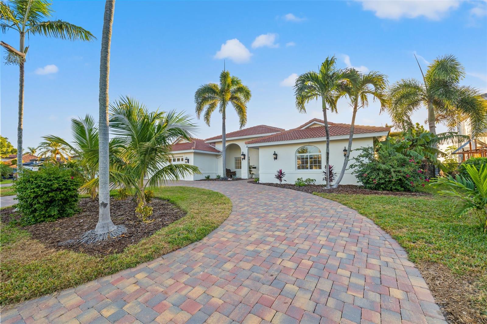 VENETIAN ISLES OPEN WATER OASIS! Experience the ultimate Florida living with unobstructed views of Tampa Bay and the ever-changing waterscape! From the paver semicircular driveway to the BRAND-NEW TILE ROOF 10/2023 and hand rolled NEW EXTERIOR PAINT 11/2023, to the PROFESSIONAL HOTEL GRADE DOCK and BOAT LIFT 2022, this home has it all! The double arched portico and Custom leaded glass French doors entice you toward the breathtaking views of Tampa Bay. Leave the world behind as you enter this oasis of water and light! The coastal design of this home encourages relaxation and entertainment as you enter the open concept living space, tastefully designed to showcase the Florida lifestyle and breathtaking beauty of Tampa Bay! Enter the expansive kitchen with center island, stainless appliances Bosch dishwasher, Samsung Triple French door fridge, Double wall ovens, and GAS cooktop. Watch the morning light dance on the wrap around breakfast bar each morning, reflected by the custom light fixtures, as you sip your morning coffee. Spacious Granite counters and rough-hewn shiplap complete this Chef’s dream kitchen. The formal dining space accommodates both intimate dinners with friends and large family celebrations. Accented by a built-in dry bar with granite counter and extra storage. Delight in the open water vistas at each turn. The home office, Everyone will envy, boasts ample space, boundless water views and private patio access through an impact rated French door. The home’s split floor plan has three spacious bedrooms and two full baths on the south side of the home.
To the north is the main suite complete with private hallway. Wake from a restful night’s sleep listening to the quiet surf to endless water views in the generous main bedroom. Private impact sliders lead to the paver patio and pool for a morning dip or star gazing at night. Step out the impact rated French doors to the paver deck, pool, and ULTIMATE BOATERS DOCK! Imagine your own 16,000 lb. dual motor high speed lift. AND a jet ski “swinger” lift that allows the jet ski to relocate to the dock deck for easy maintenance. The NEW COMPOSITE DOCK &amp; PILINGS 2022 has power, water, light tower, dusk to dawn lighting, boat shore power outlets, and two hose bibs on the dock! This is coastal Florida living at its best! Jump in the pool after a day fishing, boating, or cruising to downtown St Pete for lunch. Pool pump and filter replaced 2022. A laundry room with extra storage and an oversized two car garage complete this amazing home. Convenient and easy access to Tampa International Airport, just 25-min drive. Downtown St. Petersburg, a mere 4-mile bike or golf cart ride, partake in the vibrant tapestry of the Saturday morning market, explore award winning restaurants, boutique shopping, world-renowned art galleries including the Dali Museum, the Pier, Yacht Clubs, Morian Art Center, and private airport for your convenience. A+ schools Canterbury and Shorecrest, &amp; World-famous Beaches just moments away. All your grocery needs are easy to find with Fresh Market, Trader Joes, Rolling Oats, Publix, and a new Whole Foods.