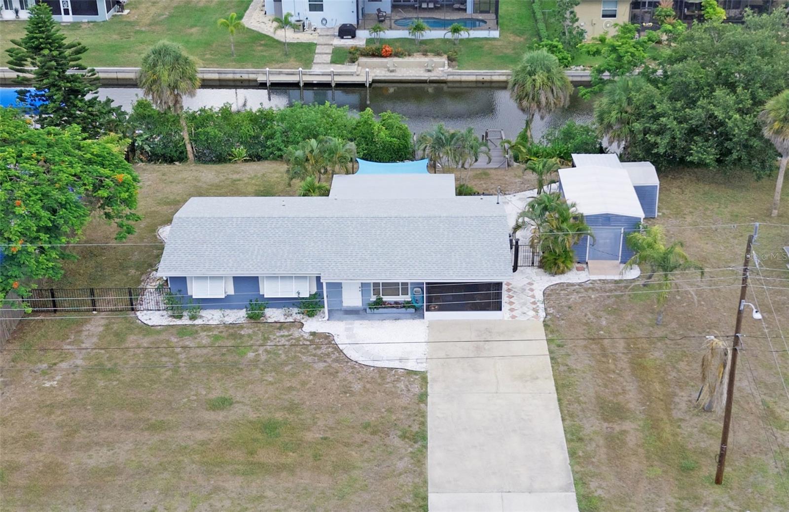 STUNNING FURNISHED WHATERFRONT HOME JUST MINUTES FROM THE BEACH
Discover the ultimate coastal living experience in this beautifully updated waterfront home, ideally located less than 3 miles from the nearest beach. Offering 100 feet of saltwater canal frontage, this property is perfect for boating enthusiasts and anglers alike, with premier access to Lemon Bay, Stump Pass, and the Gulf.
As you enter, you'll be captivated by the spacious, updated open floor plan that seamlessly integrates the main living areas. The bright and airy kitchen, complete with granite countertops and a beautiful island, offers ample storage and functionality for any culinary enthusiast. You will be drawn to the generous dining area that invites gatherings of 8 to 10 guests, all while embracing water views and the lush, large fenced-in backyard—perfect for entertaining or relaxing.
This turn-key furnished home features tile flooring throughout and a soothing neutral color palette, creating a serene atmosphere. The expansive lanai, equipped with a wood-burning stove and adjustable covered windows, serves as an ideal space for year-round enjoyment. After a day of adventure on the water, rejuvenate in the outdoor bathhouse before storing your gear in the convenient large storage shed. Take in the beautiful sunsets from the dining area or on one of the two composite wood docks.
Enjoy peace of mind knowing this home is flood-damage free. You will appreciate the beautiful window blinds on the interior and shade shutters on the exterior that ad beauty and comfort. Additional highlights include an internal laundry room and a recently replaced roof (2022). There are no HOA fees or restrictions, so bring your boat and RV!
When you decide to venture beyond your private oasis, you'll find a wealth of local attractions just moments away. Explore the historic Dearborn District, Wellen Park, and thousands of acres of scenic preserves, along with multiple state and county parks. Engage in the vibrant local community with access to incredible beaches, including Manasota Key and Boca Grande, and a variety of golf courses—all within a 10-mile radius.
Experience world-class fishing, dining, and shopping right at your doorstep. Don't miss out on this exceptional coastal retreat—schedule your private showing today!
