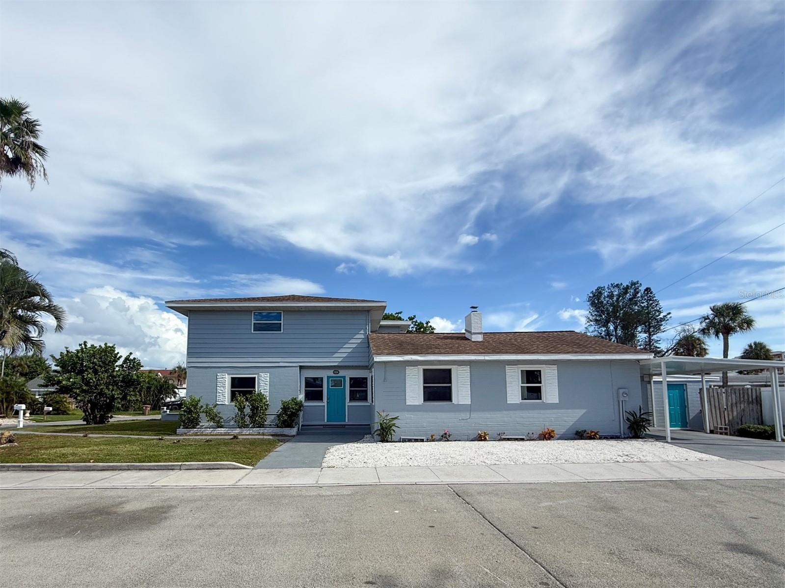 Welcome to your beautifully reimagined coastal retreat in the heart of Madeira Beach. Perfectly positioned on an oversized corner lot just a few blocks from the Gulf of Mexico, world-famous John's Pass Village, and two scenic Intracoastal pocket parks, this stunning 4-bedroom, 3.5-bath residence offers the perfect blend of modern luxury, beach-town charm, and everyday functionality. Completely renovated from top to bottom, virtually everything is brand new, creating a truly move-in-ready home with approximately 2,350 square feet of thoughtfully designed living space.

Step inside to discover an open, light-filled floor plan featuring oversized rooms throughout, including an impressive 22' x 14' living room that's perfect for entertaining or relaxing after a day at the beach. Every detail has been carefully selected, from the solid wood kitchen cabinetry and elegant quartz countertops to the stylish finishes found throughout the home. Impact-rated windows and doors provide peace of mind, energy efficiency, and abundant natural light.

The spacious kitchen serves as the heart of the home, flowing effortlessly into the main living areas. The generous primary suite offers a private retreat complete with its own ensuite bathroom, while the additional bedrooms are all oversized and provide exceptional space and flexibility for family, guests, or a home office.

Car enthusiasts, hobbyists, and those needing extra storage will appreciate the oversized one-car garage, attached 30' x 12' workshop, and additional covered carport, offering incredible versatility that's rarely found this close to the beach.

Outside, the oversized corner lot offers exceptional curb appeal with ample room to create your own tropical oasis, add a pool, or simply enjoy the coastal breezes. Located within walking distance of Madeira Beach's sugar-white sands, John's Pass Village, waterfront dining, boutique shopping, marinas, and two peaceful Intracoastal waterfront parks, you'll experience the very best of Florida's beach lifestyle. Golf-cart-friendly streets, boating, fishing, spectacular sunsets, and endless recreation are all just moments from your front door.

This is a rare opportunity to own a fully renovated, move-in-ready coastal home in one of Tampa Bay's most sought-after beach communities. Schedule your private showing today and discover why Madeira Beach is one of Florida's most treasured destinations.