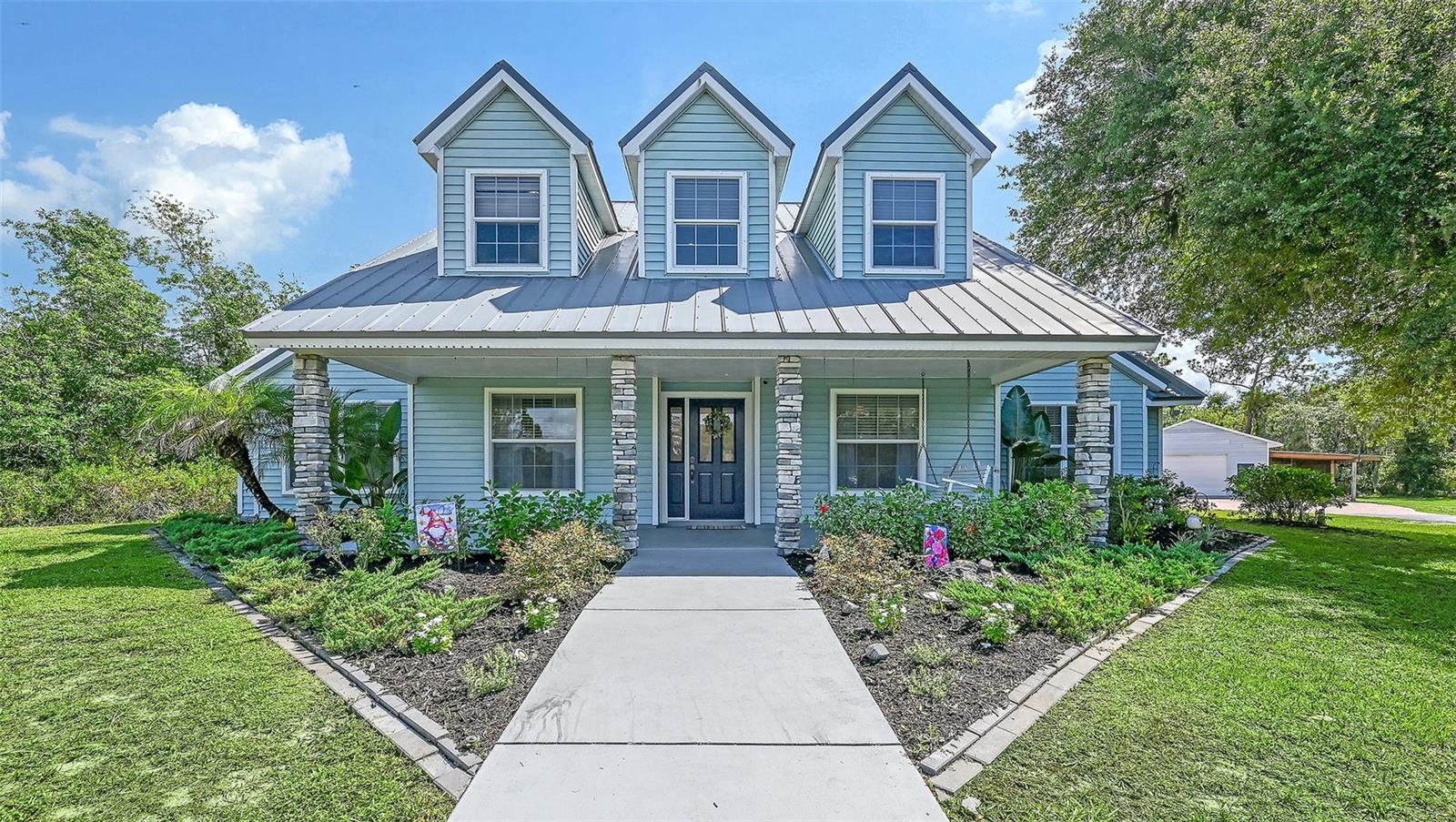 First Time Ever Offered For Sale! Welcome to a truly special property where privacy, functionality, and country charm come together on 5 picturesque acres in Myakka City. Custom built in 1994, this cherished family home has been lovingly maintained for more than 30 years and is now ready for its next chapter. With no HOA or CDD fees, you'll enjoy the freedom to truly make this property your own.

Offering over 2,900 square feet, this spacious home features 3 bedrooms, an office, 3.5 bathrooms, and a thoughtfully designed floor plan with the primary suite conveniently located on the main level. Inside, you'll appreciate the soaring vaulted ceiling, a cozy wood-burning stove, fresh interior paint, brand-new carpet, newer luxury vinyl plank flooring, and a warm, inviting atmosphere that instantly feels like home.
Step outside onto the welcoming country front porch, where you can relax with your morning coffee while overlooking majestic oak trees, a peaceful pond, and the beauty of rural Florida. Whether you're dreaming of horses, livestock, gardening, or simply enjoying wide-open spaces, this property offers endless possibilities.

The outdoor amenities are equally impressive. A 30' x 36' powered workshop provides the perfect space for hobbies, projects, or equipment storage. The property also features a 16' x 36' covered outdoor kitchen and entertaining area, a second 16' x 30'' lean-to ideal for a high tower boat, RV, or additional storage, plus a 10' x 10' lean-to for even more versatility. A two-car garage with a convenient storage breezeway adds even more functionality to this exceptional property. 

Rarely does an opportunity arise to own a property that has been lovingly cared for by the same family since it was built. If you've been searching for acreage, privacy, room for your toys and animals, and a home filled with character, this is the one you've been waiting for.