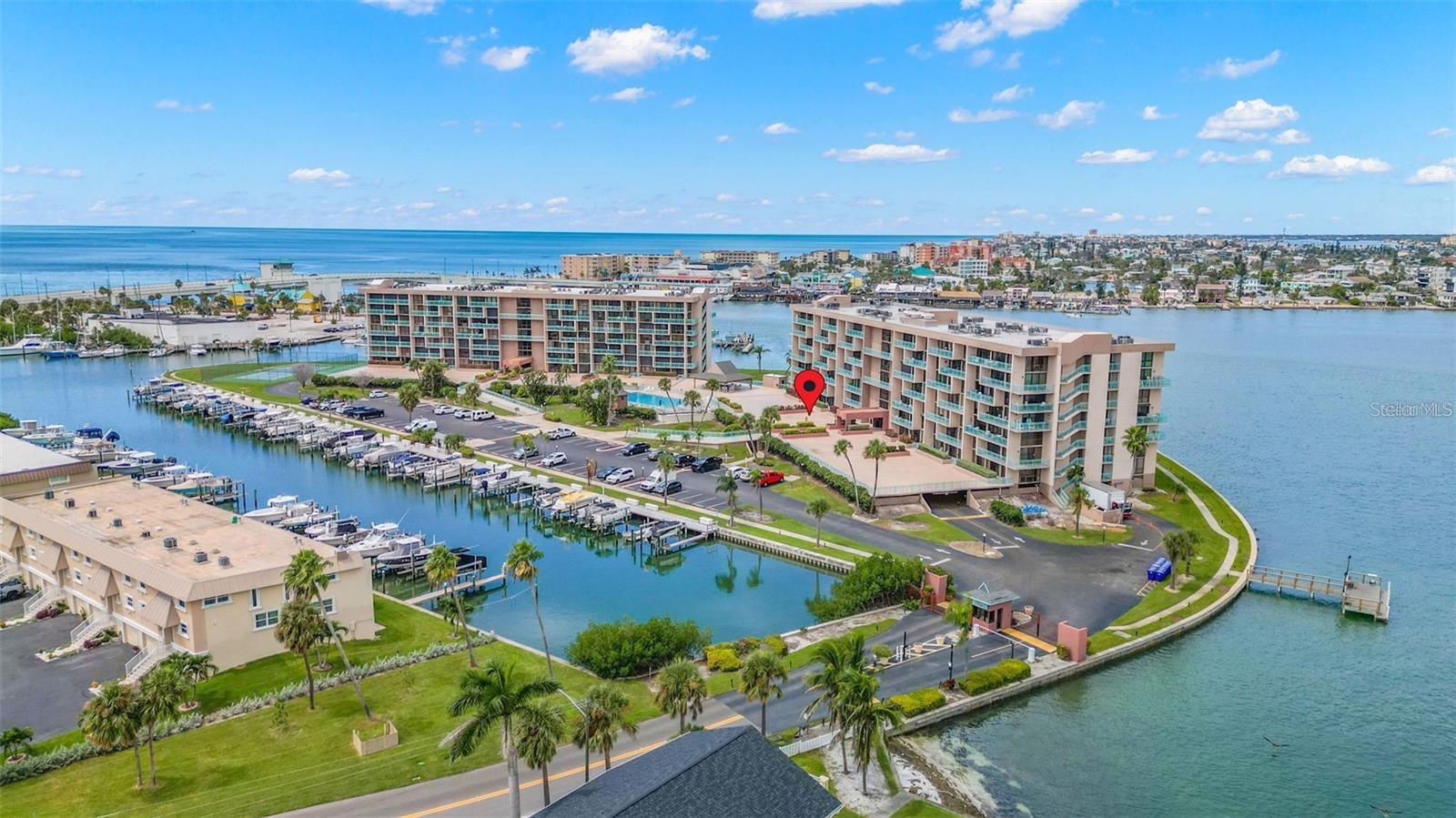 NEW PRICE - Great VALUE here ....Your Family's Florida Home Base – Welcome to Key Capri, Treasure Island's gated community on a private island overlooking John's Pass — where your family can enjoy Full Time or Second HOME true resort-style living, without the revolving door of a vacation rental, or their Hotel-Like Atmosphere!! .... This 2-bedroom, 2-bath condo is a rare find: a seldom-used, well-maintained retreat that feels like a fresh start ... The open floor plan is flooded with natural light, with floor-to-ceiling sliding glass doors opening to an oversized 35’Long+ Terrance with direct pool and spa access ... The well-equipped kitchen with nearly-newer Refrigerator and Stove flows into a separate dining room — perfect for family dinners … The split-bedroom layout gives everyone PRIVACY and breathing room, with an oversized primary suite featuring a walk-in closet and ensuite bath, and a guest suite with its own balcony access ...  In-unit washer/dryer … assigned covered parking, and a private storage shed, storm shutters for all widows, all combine to make this a genuinely comfortable primary OR home away from home....
Step outside and the community delivers: a heated and cooled pool, jacuzzi, tiki hut, tennis or pickleball court, shuffleboard, putting green, and a fitness center w/saunas — all with Wi-Fi throughout ... A Boat slip may be available by lease for boaters looking for Gulf and Intracoastal access right at their doorstep — just ask....A Rare Opportunity for Extended Families or Close Friends …The adjacent corner unit — also 2BR/2BA — is available simultaneously ... Together, the two units combine into a 4-bedroom, 4-bath, 2,350 sq ft family compound … Having two units’ side by side in the same gated waterfront community is genuinely uncommon, and worth a close look if your extended family wants to vacation together while maintaining separate spaces ....  All-inclusive fees cover internet, cable, building insurances, water, sewer, landscaping, and on-site management — so visits are about rest, not logistics ... A completed Milestone Inspection and Structural Integrity Study with full and ample reserves provide solid peace of mind ... A recent $30,000 price reduction makes this an exceptional value for money in today's coastal market … HURRY on this one – CALL TODAY for YOUR private appointment to inspect
