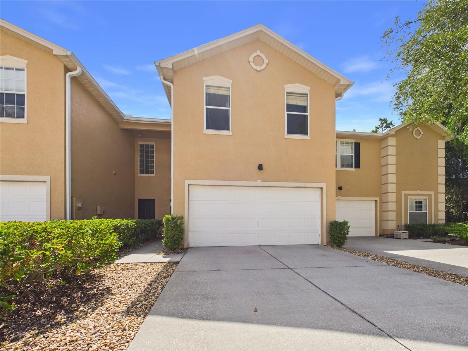 Welcome to this well-maintained 3-bedroom, 2.5-bath home with a spacious two-car garage, located in the sought-after gated community of Emerald Pointe in the heart of New Tampa. Step inside to an inviting open-concept floor plan featuring generous living and dining areas that provide the perfect setting for both everyday living and entertaining. The well-appointed kitchen comes complete with all appliances and offers a breakfast bar, pantry, recessed lighting, and a built-in desk area for added convenience and functionality. All bedrooms are situated upstairs, including the spacious primary suite featuring a private en-suite bath with dual vanities, a walk-in shower, and an oversized walk-in closet. Enjoy peaceful mornings or relaxing evenings on the private patio overlooking a serene conservation area, creating a tranquil outdoor retreat. Ideally located directly across from Tampa Palms Golf & Country Club, this home offers exceptional access to University of South Florida, Moffitt Cancer Center, The Shops at Wiregrass, Tampa Premium Outlets, shopping, dining, the YMCA, and I-75 for an easy commute throughout the Tampa Bay area.