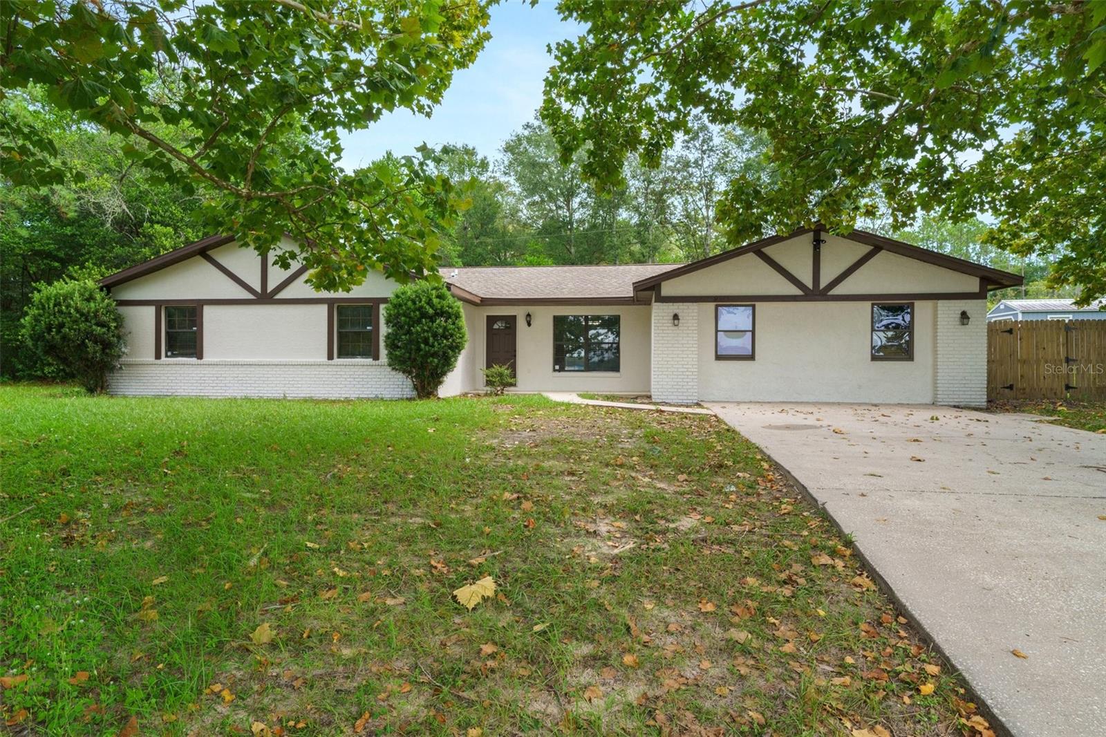 Spacious 4 Bedroom, 3-bathroom pool home with over 2,500 sq feet of living space on a .6-acre double lot. New paint inside and out. This home has a living room and a family room, an open floor plan, fireplace. The master suite comes complete with an en-suite bathroom and generous closet space. Three additional bedrooms provide plenty of room for family and guests.  This was a model home so the garage is a large bedroom, which could be a second master suite or in-law suite. Step onto the expansive patio, and you'll be greeted by your very own pool, beckoning you to take a refreshing dip or simply lounge under the warm Florida sun. Plenty of space for outdoor activities, whether you're envisioning a play area, a flourishing garden, or simply a peaceful retreat to unwind and recharge. Located in the sought-after community of Citrus Springs, this property provides the perfect blend of suburban tranquility and convenience. Sellers are motivated, make offer.  Ask your lender about rate buy-down.