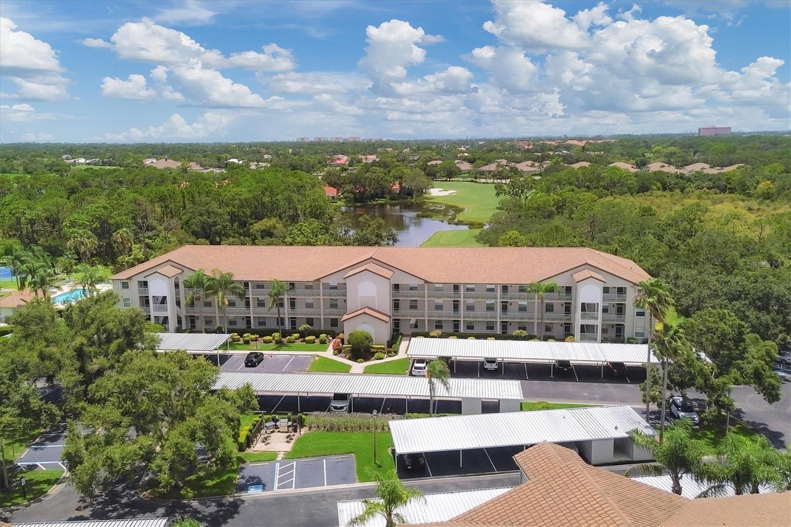 Enjoy breathtaking sunset views over the pond and 9th tee box from this beautifully maintained 2-bedroom, 2-bath condo in the desirable Terraces at Stoneybrook Golf & Country Club. Surrounded by swaying palms and mature live oaks, this light-filled residence features an open, split floor plan offering privacy and comfort. The spacious primary suite includes golf course views, lanai access, two closets (including a custom walk-in), and an ensuite bath with separate shower and water closet. The updated kitchen boasts solid wood cabinetry, granite countertops, and neutral tile flooring, opening to the dining and living areas and a glass-enclosed lanai—perfect for relaxing or entertaining. The guest bedroom with Murphy bed and adjacent full bath provide flexible space for visitors. Additional highlights include a covered carport, private storage closet, and access to the resort- style pool, grilling area, and tennis/pickleball courts. Stoneybrook Golf & Country Club offers an exceptional lifestyle with the newly modernized 18-hole golf course, Har-Tru tennis courts, bocce, fitness center, and indoor & outdoor clubhouse dining. Conveniently located near the Legacy Trail, shopping, dining, and the beaches of Siesta Key and Nokomis. Experience the best of maintenance-free living in one of Sarasota’s premier gated communities. Nowhere but here-Stoneybrook!
