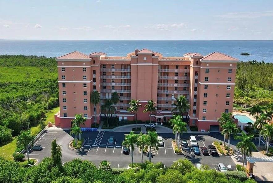 Exceptional Value with Golf Cart Included!  Experience luxury waterfront living in Vista Del Sol at Burnt Store Marina. This beautifully appointed 6th-floor end-unit condo offers breathtaking marina and harbor views, abundant natural light, and enhanced privacy thanks to its desirable end-unit location. The open-concept floor plan features spacious living and dining areas that flow seamlessly to the private lanai, providing the perfect setting to relax and enjoy the picturesque waterfront scenery. The primary suite serves as a peaceful retreat with lanai access, water views, and an ensuite bath. The generously sized guest bedroom also features its own private ensuite bathroom, offering comfort and privacy for family and guests.
Additional highlights include under-building parking, a golf cart included with the sale, ample storage, and access to the resort-style amenities Burnt Store Marina is known for. Conveniently located near boating, golf, dining, fitness facilities, tennis, and pickleball, this exceptional residence offers the ultimate Southwest Florida lifestyle.
Competitively priced and offering privacy and spectacular marina and harbor views, this premier end-unit is a rare opportunity in one of Burnt Store Marina's most sought-after communities. Schedule your private showing today!
