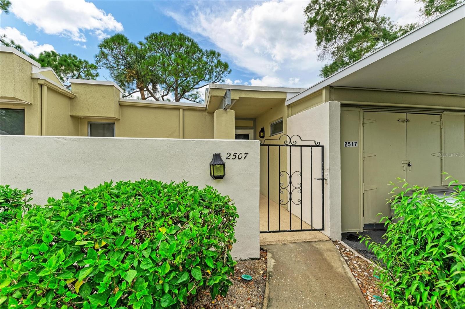 What a wonderful opportunity to love living life in highly sought after Meadowlake in the peaceful golfing community of The Meadows in this light and bright newly renovated villa. As you enter through your private Gated Courtyard, you’re immediately taken back by the charm of this spacious corner unit and the fresh open feel of the expansive living room with high ceilings, fresh paint, and neutral luxury vinyl plank flooring. Entertainment is a breeze with Sliding glass doors in every room that open to the immense screened private lanai space that wraps around the kitchen, living room and primary suite where natural light abounds for the ultimate Florida lifestyle. Enjoy your brand-new designer kitchen with Sparkling Quartz counter tops, soft close white shaker cabinets with transitional brushed nickel hardware, stunning neutral backsplash, stainless appliances and lighted water flow faucet.  The primary bathroom has also received a fresh renovation that includes a new tub with designer tile and has a large new soft close vanity with quartz counters that is separate from the rest of the bathroom amenities allowing for privacy and space. The guest bathroom has also had a fresh makeover. This unit also features an indoor laundry room and private covered carport with a personal outdoor storage room for convenience. The meadows is known for its beautiful nature rich surroundings with plentiful wildlife, nature trails with sprawling green spaces. Residents can relax in one of the two heated community pools and enjoy The Meadows Country Club which offers amenities for an active lifestyle including a clubhouse, three 18-hole golf courses, social activities, and tennis. Membership opportunities are available, but membership is not required. Fitness Center and Clubhouse pool are included. This location is a short drive to the Gulf beaches, St. Armands Circle, and the UTC mall.