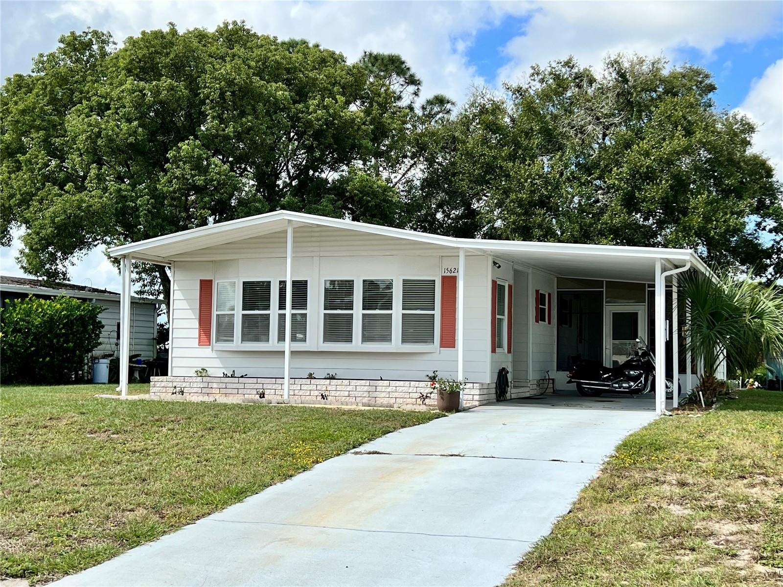 Under contract-accepting backup offers. Discover the BEST of Florida living in this 2-bedroom, 2-bath home boasting a spacious 1219 square feet of living space. Nestled in one of the area's most vibrant 55+ communities, this residence is a treasure trove of amenities and social events for everyone to enjoy.  The home features a BRAND-NEW AC system in 2023, NEW roof in 2019, updated vinyl flooring throughout the home, screened in patio with hot tub, enclosed workshop area, laundry room with separate AC, covered parking, fresh exterior paint and much more.  When entering the home, you are greeted by an open floor plan with a naturally bright Florida room, perfect for morning coffees and taking in the Florida sun.  The home features a large 19 x 13 living room, comfortable kitchen space, built in cabinetry in the dining room and plenty of room in the bedrooms.  Ready for the next own, this home is spacious yet cozy.  Live here year-round or make this Brookridge home your seasonal vacation destination. While not in use the home can be rented for potential passive income for short-term, seasonal or annual rentals. Take in relaxing days at the heated pool all year long or a round of golf with friends.  Play a game of pickleball or challenge your neighbor at horseshoes.  The gated community of Brookridge is located in the rolling hills of Brooksville yet less than 15 miles from the beautiful Gulf Beach of Pine Island and less than an hour drive to Tampa airport and everything that Tampa has to offer.  Additional community amenities include a large clubhouse, monthly social dances, aquatic exercise, lighted tennis courts, shuffleboard courts, horseshoe and bocce courts, ceramics, library, computer room, fitness center, picnic pavilion, social clubs, social events, seasonal Vegas style shows, poker/card room, bingo, golf cart friendly and even RV parking for residents...all of this included in the VERY LOW $40 monthly HOA fee!  Unbelievable value packed into this home.  Schedule your private showing today!
