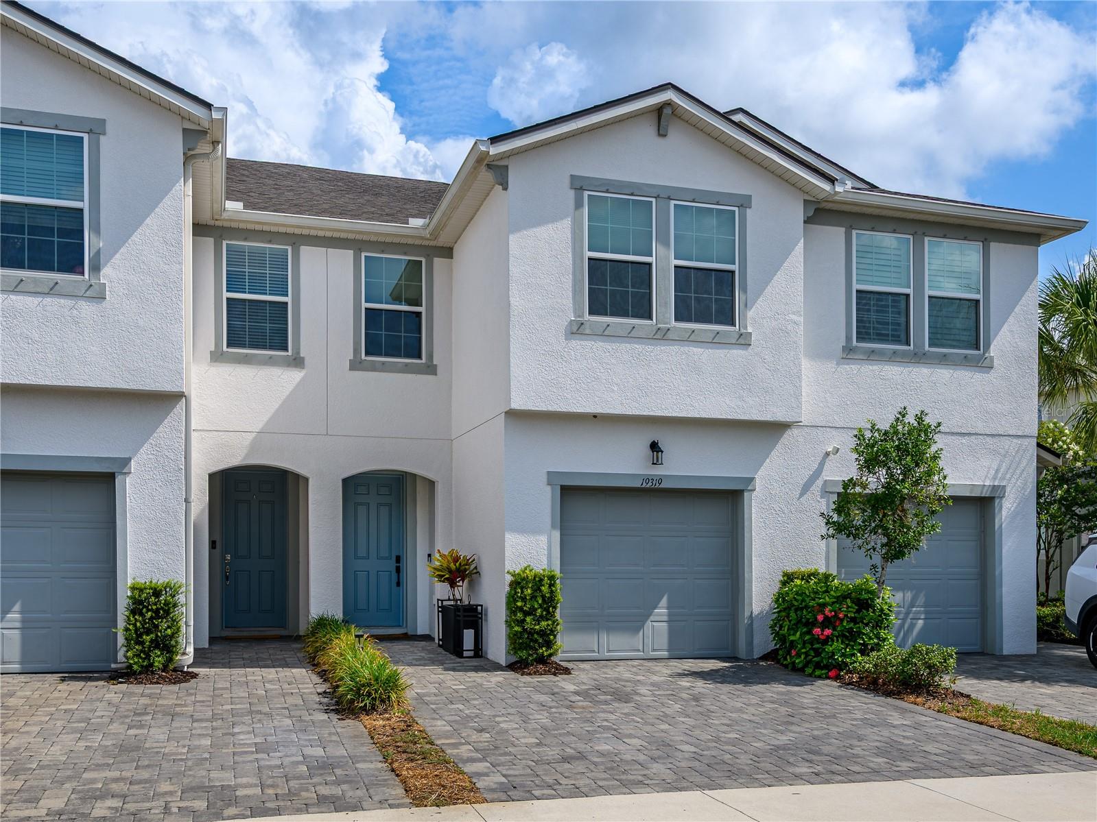 Move-in ready townhome featuring thoughtful upgrades throughout! The open-concept layout is highlighted by an impressive 7’ x 7’ oversized kitchen island, large wood-look plank tile flooring, fresh professional interior paint, crown molding, designer kitchen and foyer lighting, upgraded ceiling fans, updated kitchen and bathroom hardware, and a beautifully upgraded primary shower. Enjoy the screened lanai with a custom tongue-and-groove ceiling, plus a matching tongue-and-groove front porch that adds exceptional curb appeal. Additional features include upgraded exterior lighting and four TV mounts that convey. Ideally located near shopping, dining, parks, and top-rated schools, this low-maintenance townhome offers the perfect blend of style, comfort, and convenience.