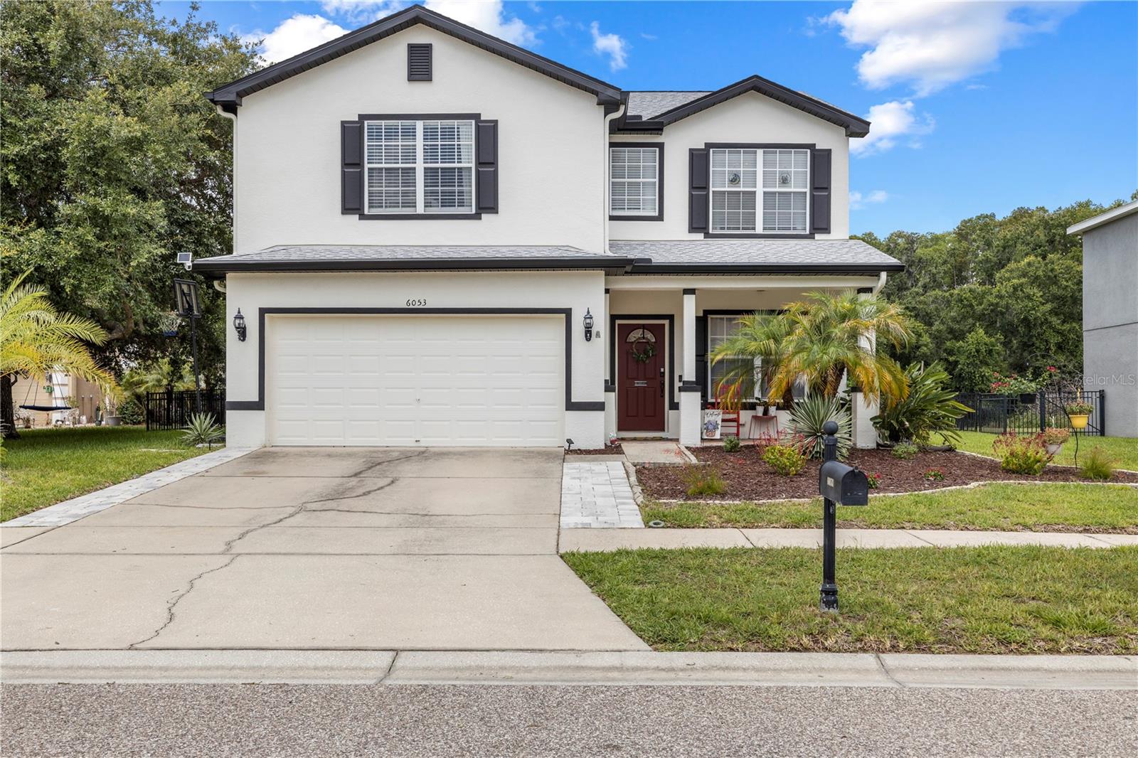 Welcome to this beautifully updated 4-bedroom, 2.5-bath home in the desirable Dupree Lakes community of Land O’ Lakes, Florida. This spacious two-story home offers an open floor plan with vaulted ceilings, tile flooring throughout the main living areas, fresh first-floor interior paint, updated lighting fixtures, and a warm built-in electric fireplace with mantle. The renovated eat-in kitchen, completed in August 2023, features resurfaced cabinets with new cabinet doors and hardware, crown molding above the cabinetry, a custom bump-up above the microwave, granite countertops, an oversized deep stainless steel sink, new faucet, and stainless steel appliances including the refrigerator, oven, microwave, and dishwasher. The main level also includes a formal living room near the entry, ideal for a home office, sitting room, or additional entertaining space, along with a dining area featuring luxury vinyl plank flooring installed in 2023. Upstairs, the spacious loft offers the perfect bonus room, media space, playroom, or second living area, enhanced by custom floor-to-ceiling bookcases installed in 2024. The second floor was updated with luxury vinyl plank flooring in October 2025, while the stairs feature premium plush carpet. The private primary suite offers a relaxing retreat with a dual-sink vanity, tiled shower, and large soaking tub. Three additional bedrooms and a full bathroom provide plenty of flexible space for guests, work, or hobbies. The half bathroom was renovated in August 2023 with resurfaced cabinetry to match the kitchen, granite countertop, new sink, faucet, cabinet doors, hardware, and toilet. Major exterior and mechanical updates add peace of mind, including a new roof installed in 2024, fresh exterior paint with an updated color palette, rear gutters, extended driveway pavers, a 2024 water heater, and a whole-home water softener installed in 2023. Enjoy Florida outdoor living from the fully screened lanai overlooking the large fenced backyard with peaceful pond and preserve views. A two-car garage and private driveway provide ample parking. Dupree Lakes residents enjoy low HOA dues with access to community amenities including a resort-style pool, fitness center, clubhouse, and playground. Conveniently located in Land O’ Lakes near shopping, dining, schools, parks, and major roadways, this updated Dupree Lakes home offers comfort, space, upgrades, and beautiful views in one of Pasco County’s popular communities.