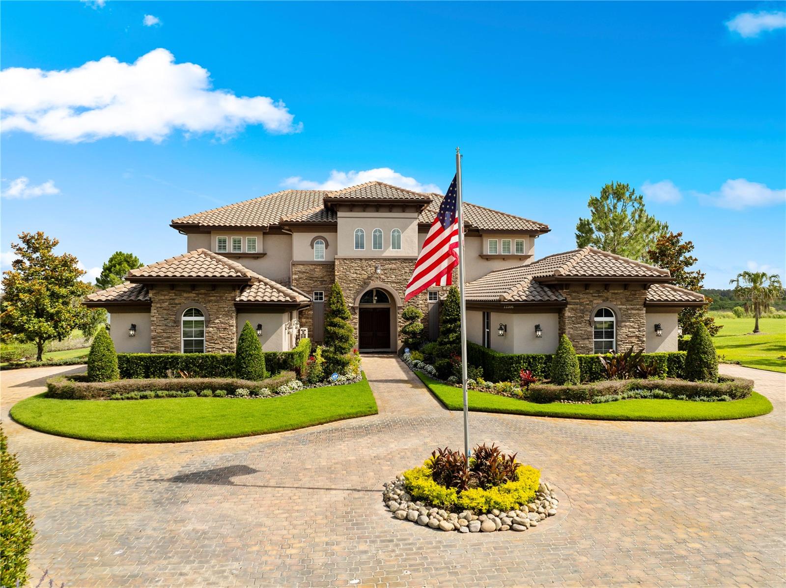Welcome to an extraordinary lakefront estate in Stonelake Ranch, where timeless elegance, unparalleled craftsmanship, and breathtaking views come together on over 2 acres of pristine property. This magnificent 5-bedroom, 6.5-bath residence offers luxury at every turn, featuring exquisite travertine flooring, soaring ceilings, intricate decorative moldings, stunning coffered and tray ceilings, and rich wood beam accents that add warmth and architectural character throughout. A dramatic stone feature wall in the dining room creates a striking focal point, showcasing the exceptional attention to detail found in every corner of the home.

At the heart of the home lies an impressive chef's kitchen, thoughtfully designed for both culinary excellence and effortless entertaining. Featuring an immense center island, premium finishes, and a hidden-door walk-in pantry, this exceptional space seamlessly connects to the surrounding living and dining areas while showcasing breathtaking panoramic lake views.

Retreat to lavish bedroom suites, each thoughtfully designed with comfort and privacy in mind. The luxurious primary suite offers a private sanctuary, while the home's thoughtfully curated living spaces provide elegance, comfort, and flexibility for both everyday living and grand-scale entertaining.

Step outside to your own private resort-style oasis, where indoor and outdoor living blend seamlessly. Enjoy a sparkling pool and spa, expansive covered lanai, outdoor kitchen, and beautiful travertine decking, all perfectly positioned to capture sweeping lake views and spectacular Florida skies. The home's impressive elevation, stately presence, long paver-stone driveway, and four air-conditioned garage spaces create a grand first impression while providing exceptional functionality. And don't miss the whole house generator to keep you comfortable at all times in case of a power outage 

Nestled within the exclusive gated enclave of Stonelake Ranch, residents enjoy a resort-inspired lifestyle surrounded by more than 680 acres of scenic landscape and natural beauty. Community amenities include private access to the 880-acre Lake Thonotosassa via a private boat ramp, a beautifully appointed lodge with a 24-hour fitness center, tennis, basketball, and pickleball courts, and miles of trails designed for walking, hiking, and equestrian pursuits. Combining tranquility with convenience, this premier location offers easy access to Downtown Tampa, I-75, I-4, Tampa International Airport, and the Gulf Coast's finest beaches, dining, and entertainment destinations.

This is more than a home—it is a private sanctuary where luxury, lifestyle, and location converge. Rarely does an estate of this caliber become available. Experience the pinnacle of lakefront luxury living and discover why Stonelake Ranch remains one of the Tampa Bay area's most coveted luxury communities. Schedule your private tour today.