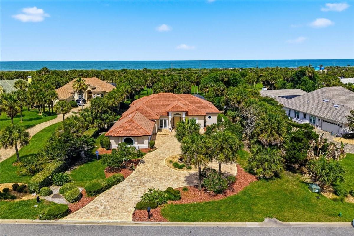 Welcome to one of the most extraordinary waterfront estates in Palm Coast. Located within the prestigious Island Estates community of Hammock Dunes, this custom-built luxury residence offers a lifestyle that few properties can match. Nestled between the Fox Cut Canal and the Intracoastal Waterway, Island Estates is an exclusive gated enclave of only 190 homes with just a handful of vacant homesites remaining. This private waterfront community offers 24-hour staffed security, unmatched privacy, and one of the most unique lifestyle opportunities on Florida’s east coast.    Situated on a spectacular 1.39-acre waterfront homesite, this concrete block estate boasts over 3,900 square feet of beautifully designed living space featuring four bedrooms, four full bathrooms, a private office, and a detached casita, creating the perfect setup for guests, extended family, or a private retreat.    Lovingly updated over the years, the home showcases newer tile flooring, a beautifully renovated kitchen, and tastefully updated bathrooms throughout. The spacious floor plan is designed to embrace both everyday living and entertaining, with the upgraded kitchen opening seamlessly to the family room and overlooking the stunning outdoor living spaces. The luxurious primary suite serves as a private sanctuary featuring a spa-inspired bathroom with a gorgeous glass-enclosed shower. A separate sitting room overlooking the pool offers endless possibilities as a library, fitness room, media room, or quiet retreat.   Step outside and discover your own private resort. The sparkling pool and spa create the perfect backdrop for relaxing and entertaining, while a concrete walkway leads directly to the covered boat dock. With direct access to the Intracoastal Waterway, boating enthusiasts will appreciate the convenience of having endless waterfront adventures right from their backyard.   What truly sets this property apart is the rare opportunity to enjoy both waterfront and beach lifestyles in one exclusive community. Island Estates residents enjoy private beach access available only to homeowners within the community. Take a short stroll across the private beach walkover and find yourself on the beautiful sands of the Atlantic Ocean. Whether it’s boating at sunset, fishing from your dock, kayaking the Intracoastal, or enjoying a sunrise walk along the beach, this property offers the very best of Florida coastal living.   Additional features include a spacious side-entry garage and an extended driveway capable of accommodating multiple vehicles and guests with ease.   Optional membership to the Hammock Dunes Club provides access to two championship golf courses designed by Tom Fazio and Rees Jones, along with exceptional dining, fitness facilities, tennis, pickleball, resort-style pools, and a vibrant social calendar.    Properties offering this level of privacy, acreage, luxury, boating access, private beach access, and prestigious location rarely become available. This is more than a home—it is a coastal waterfront estate designed for those who want the very best of Florida living. Must see to truly appreciate everything this remarkable property has to offer.