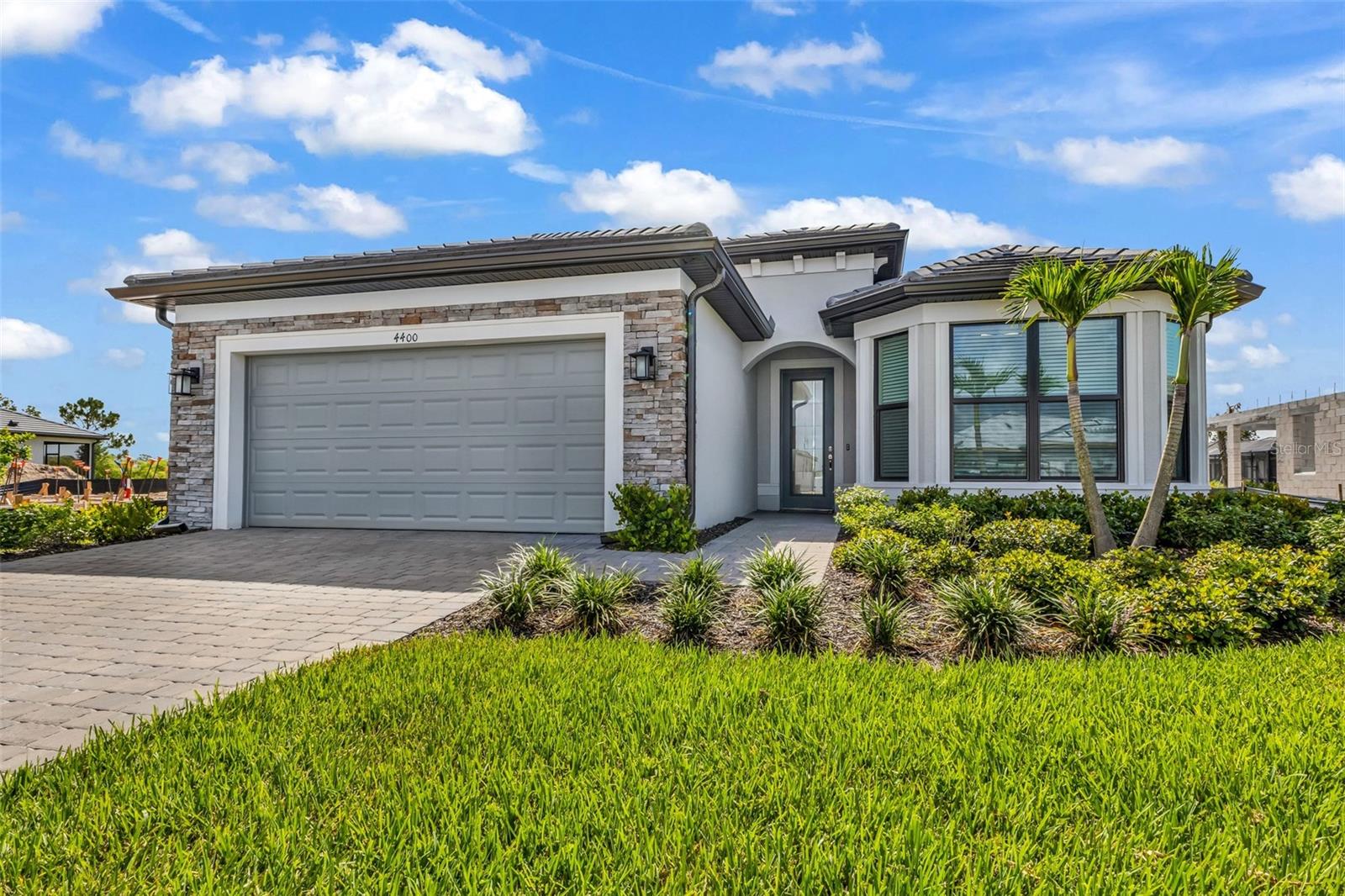 Why wait months for new construction when you can move into this nearly-new water view home today?

Built by Pulte and lived in for less than three months, this Mystique floor plan offers the upgrades buyers typically spend months selecting and thousands more adding after closing.

Situated on a premium lakefront homesite in Arbor Oaks at The Woodlands, this 3-bedroom, 3-bath home with a private flex room features over 2,250 square feet of thoughtfully designed living space, including an extended gathering room rarely found in comparable homes.

The kitchen combines style and function with quartz countertops, soft-close shaker cabinetry, subway tile backsplash, natural gas cooktop, wall oven, microwave, large walk-in pantry, and an oversized breakfast bar.

The split-bedroom floor plan provides privacy for owners and guests alike, including an en-suite guest bedroom and a spacious primary suite overlooking the water.

Unlike many builder inventory homes, the upgrades are already complete:

? Impact windows and doors throughout
? Extended gathering room
? Premium waterfront homesite
? Epoxy garage floor
? EV charging station
? Utility sink and cabinetry in laundry room
? Transferable builder warranty

Outside, there is plenty of room to add a future pool while enjoying peaceful lake views.

Residents of gated Arbor Oaks enjoy a resort-inspired lifestyle with a clubhouse, heated pool and spa, pickleball, tennis, fitness center, bocce courts, dog park, fire pit lounge, BBQ area, activities director, and the popular Barefoot Bar.

Located in a flood zone X and conveniently located near I-75, shopping, golf, Wellen Park, CoolToday Park, and Gulf beaches.

The hard work is already done. The upgrades are already installed. The warranty still transfers.

All that's missing is the new owner.
