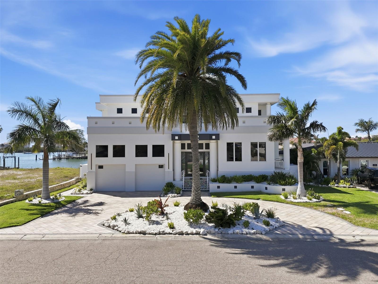 Not every waterfront home is built the same—some are simply placed on the water. Others are designed to live with it.
Welcome to 42 Midway, where luxury, privacy, and true coastal living come together in one of Clearwater Beach’s most sought-after waterfront communities, Island Estates.
This 4-bedroom, 3.5-bath residence offers nearly 5,000 square feet of thoughtfully designed space, where walls of glass frame sweeping water views and natural light pours into every corner. The layout flows effortlessly, creating the perfect balance between refined entertaining and relaxed everyday living.
At the center of the home, the chef’s kitchen is both functional and impressive—featuring high-end appliances, custom cabinetry, and a seamless connection to the main living areas so you’re always part of the moment.
Upstairs and down, the home continues to deliver—spacious bedrooms, elevated finishes, and water views that never get old.
Step outside and the experience shifts from impressive to unforgettable. Your private outdoor retreat features a resort-style pool and spa, lush tropical landscaping, and a fully equipped outdoor kitchen built for hosting. Just beyond, your private dock and boat lift provide direct Gulf access—turning spontaneous sunset cruises into a daily option, not a special occasion.
Homes like this don’t just offer features—they offer a lifestyle. Quiet mornings on the water, afternoons on the boat, and evenings entertaining under the Florida sky.
If you’ve been waiting for a Clearwater Beach waterfront home that truly delivers on location, design, and livability—this is the one worth seeing.