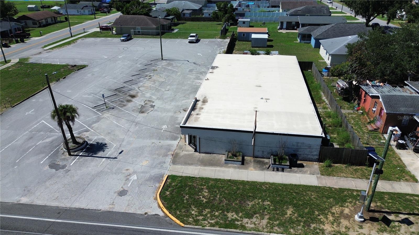 Prime commercial opportunity located on a high-visibility corner lot with ample paved parking and excellent access. This versatile property features a large open interior layout, making it ideal for a variety of uses including retail, office, church, event space, community center, or redevelopment. The building offers expansive gathering areas, multiple rooms, existing HVAC infrastructure, and flexible floor plans ready for customization. Situated on a prominent corner with strong traffic exposure and surrounded by established residential neighborhoods, this property presents endless possibilities for investors, business owners, or organizations seeking a well-positioned location with significant parking and future growth potential.