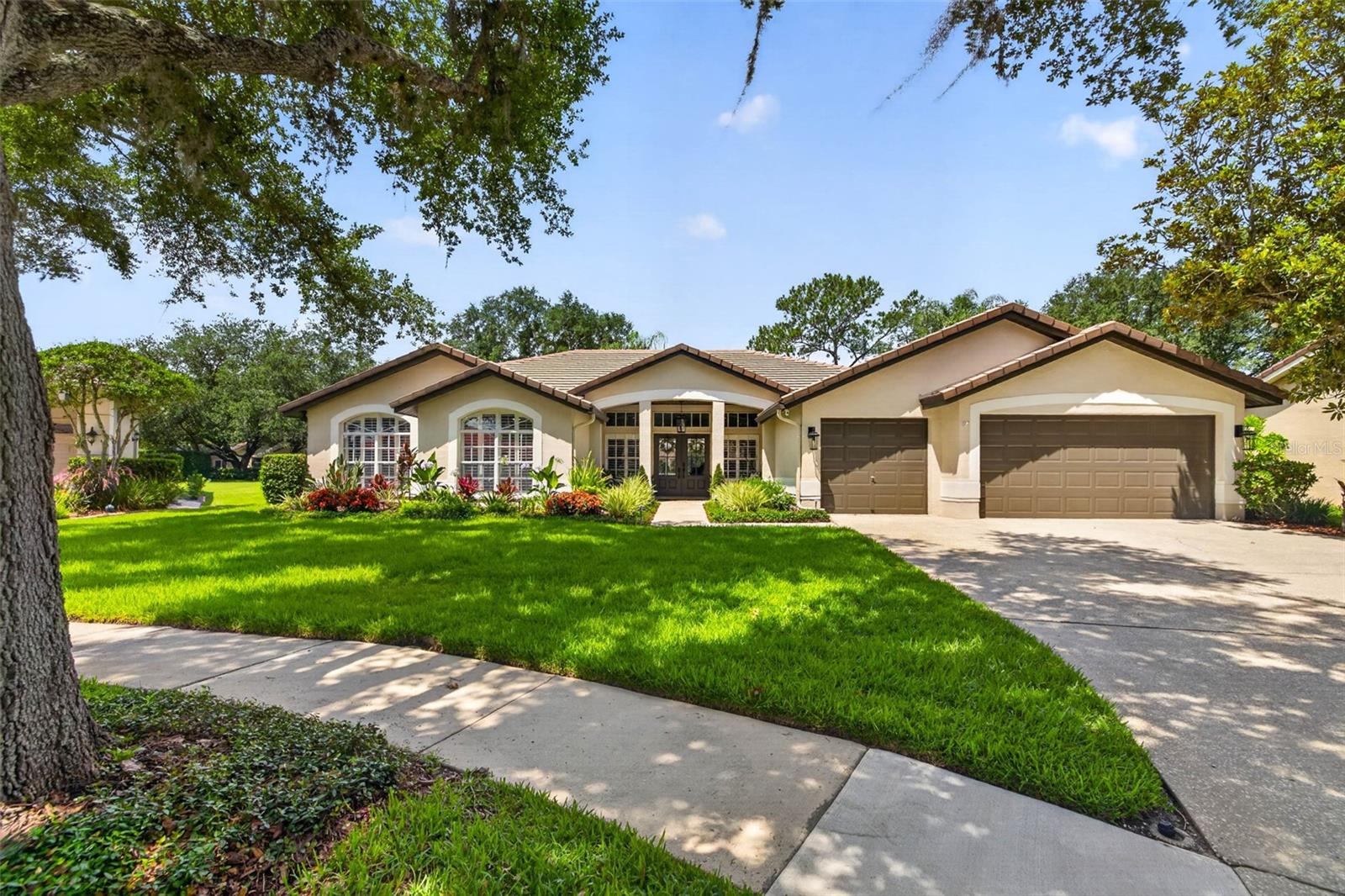 Perfectly positioned at the end of a cul-de-sac in the highly sought-after Osprey Pointe section of Hunters Green Country Club, this exceptional residence has been beautifully updated with high-end finishes, timeless craftsmanship, and modern updates rarely found in a mature neighborhood. Offering 4 bedrooms, a bonus room with private bath (ideal as a 5th bedroom, guest suite, or media room), 4 full baths, and a 3-car garage, the home has it all. Plantation shutters engineered hardwood floors, extensive millwork, wainscoting, shiplap accents, crown molding, designer lighting, and updated Craftsman-style doors create a timeless feel throughout.  The kitchen is the centerpiece of the home, featuring Cambria quartz countertops, an oversized island, double ovens, a gas cooktop, KitchenAid appliances, a built-in ice maker, and abundant custom cabinetry extending to the ceiling. The adjoining family room is anchored by a striking stone fireplace and custom built-ins, while the breakfast nook offers built-in banquet seating with storage overlooking the pool. The private primary suite includes lanai access, custom built-ins, a spacious walk-in closet, and a beautifully renovated bath with marble finishes, dual vanities, a soaking tub, and an oversized shower. Tucked away on this side of the home is an additional bedroom. Bedrooms three and four share an updated bath, while the recently added bonus room offers exceptional flexibility with its own bath and pool access. Additional upgrades include two tankless gas water heaters, two HVAC systems, smart home technology with WiFi-enabled lighting, climate control and irrigation, surround sound, fresh exterior paint, and recently refreshed interior paint. Outdoor living is equally impressive, centered around a heated PebbleTec pool with travertine decking, color-changing LED lighting, three covered sitting areas with tongue-and-groove ceilings, landscape lighting, built-in speakers, and a fully equipped outdoor kitchen. The backyard is equipped with an invisible pet fence system, providing a secure and unobtrusive way for pets to enjoy the outdoor space while preserving the beauty of the landscape. Situated on .38 acres, this exceptional home offers the quality, character, and attention to detail that discerning buyers will immediately appreciate. Hunter’s Green is a highly sought-after, 24-hour manned gated community known for its mature landscaping, championship golf course, and strong sense of community, conveniently located near I-75 with easy access to shopping, dining, and everyday essentials, and adjacent to Flatwoods Conservation Park where miles of scenic biking and walking trails provide a peaceful natural setting. Close to AdventHealth, Moffitt Cancer Center, BayCare, and the newly developing Johns Hopkins All Children's Hospital campus.