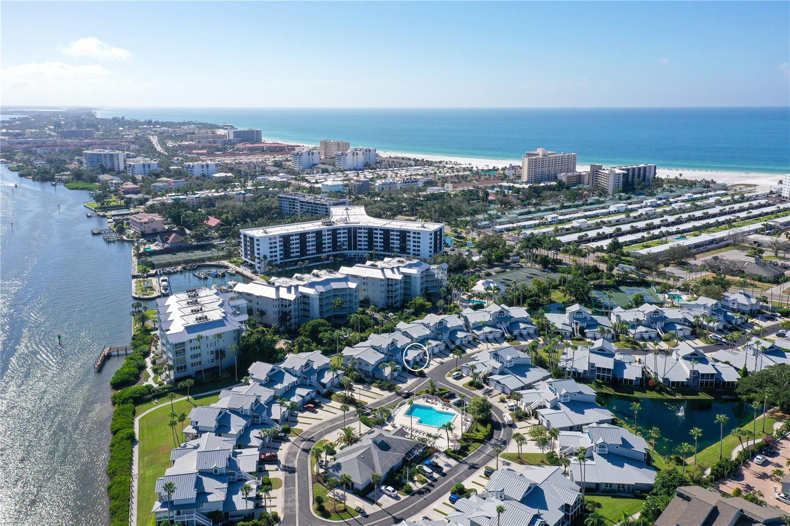 Welcome to Gulf & Bay Club Bayside, one of Siesta Key’s most desirable resort-style communities. This turnkey-furnished residence offers the perfect blend of coastal comfort, modern updates, and access to Siesta Key’s world-famous beaches. Designed with a bright, open layout and porcelain tile flooring throughout, the interior feels fresh and inviting from the moment you step inside. Oversized windows and glass sliders fill the home with natural light and extend the living space to the screen-protected lanai, creating an ideal spot to relax after a day at the beach.
The updated kitchen features stone countertops, contemporary cabinetry, quality appliances, and generous storage. The dining and living spaces connect effortlessly, giving the residence a comfortable flow for both everyday living and seasonal enjoyment. Both bedrooms provide privacy for owners and guests, and the primary suite features a walk-in closet, en-suite bath, and direct access to the lanai. A second bedroom serves well as a guest room, home office, or multi-use space.
Gulf & Bay Club Bayside is known for its beautiful coastal architecture and outstanding amenities. Residents enjoy two heated swimming pools, tennis courts, pickleball, a well-equipped fitness center, grilling stations, a fishing dock on the Intracoastal Waterway, and a stylish clubhouse. The community’s deeded walking beach access—located directly across the street—places you moments from Siesta Beach’s unique shores and turquoise water, making it effortless to enjoy sunrise or sunset strolls, and spontaneous beach days.
Situated in the heart of Siesta Key, the location offers quick access to the island’s best attractions. Explore nearby Siesta Village, known for its open-air restaurants, boutique shops, live music, and laid-back coastal atmosphere. Boaters will appreciate the proximity to the Intracoastal Waterway, marinas, and local rental options. For even more dining, arts, and entertainment, vibrant downtown Sarasota is just a short drive away—home to the Sarasota Opera House, Van Wezel Performing Arts Hall, Selby Gardens, the Ringling Museum, St. Armands Circle, and an ever-growing culinary scene.
Whether you’re seeking a full-time residence, a seasonal getaway, or an investment opportunity with weekly rentals permitted, this Gulf & Bay Club Bayside property delivers the ideal combination of location, lifestyle, and value on Siesta Key.