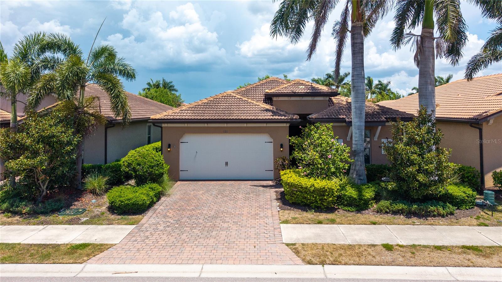 This beautiful single-family home features 3 bedrooms plus a den and 2 bathrooms, located in the highly desirable gated community of Toscana Isles. The flexible den space can easily be used as a home office, den, or even a fourth bedroom. The home showcases an open floor plan with a well-appointed kitchen featuring a center island, granite countertops, crown molding, a walk-in pantry, and an adjoining dining area. Sliding glass doors from the dining space lead to a screened-in lanai, perfect for indoor-outdoor living. The main living areas feature ceramic tile flooring, while the bedrooms are comfortably carpeted. The primary suite offers dual walk-in closets and an ensuite bathroom with double vanities and a walk-in shower. Additional highlights include a tile roof, brick paver driveway, and covered lanai. Toscana Isles is a maintenance-free community offering resort-style amenities designed for an active and social lifestyle. Residents enjoy a heated community pool, a lakefront clubhouse with a catering kitchen, billiards room with bar and TVs, modern fitness center, tennis, pickleball, and bocce courts, as well as a playground and large fire pit. The community also offers opportunities for fishing, kayaking, and canoeing on its scenic lakes. Ideally located, Toscana Isles is just a short drive from downtown Venice and Sarasota, with convenient access to restaurants, shopping, the Legacy Trail, I-75, Tamiami Trail (US-41), and the new Sarasota Memorial Hospital Venice Campus.