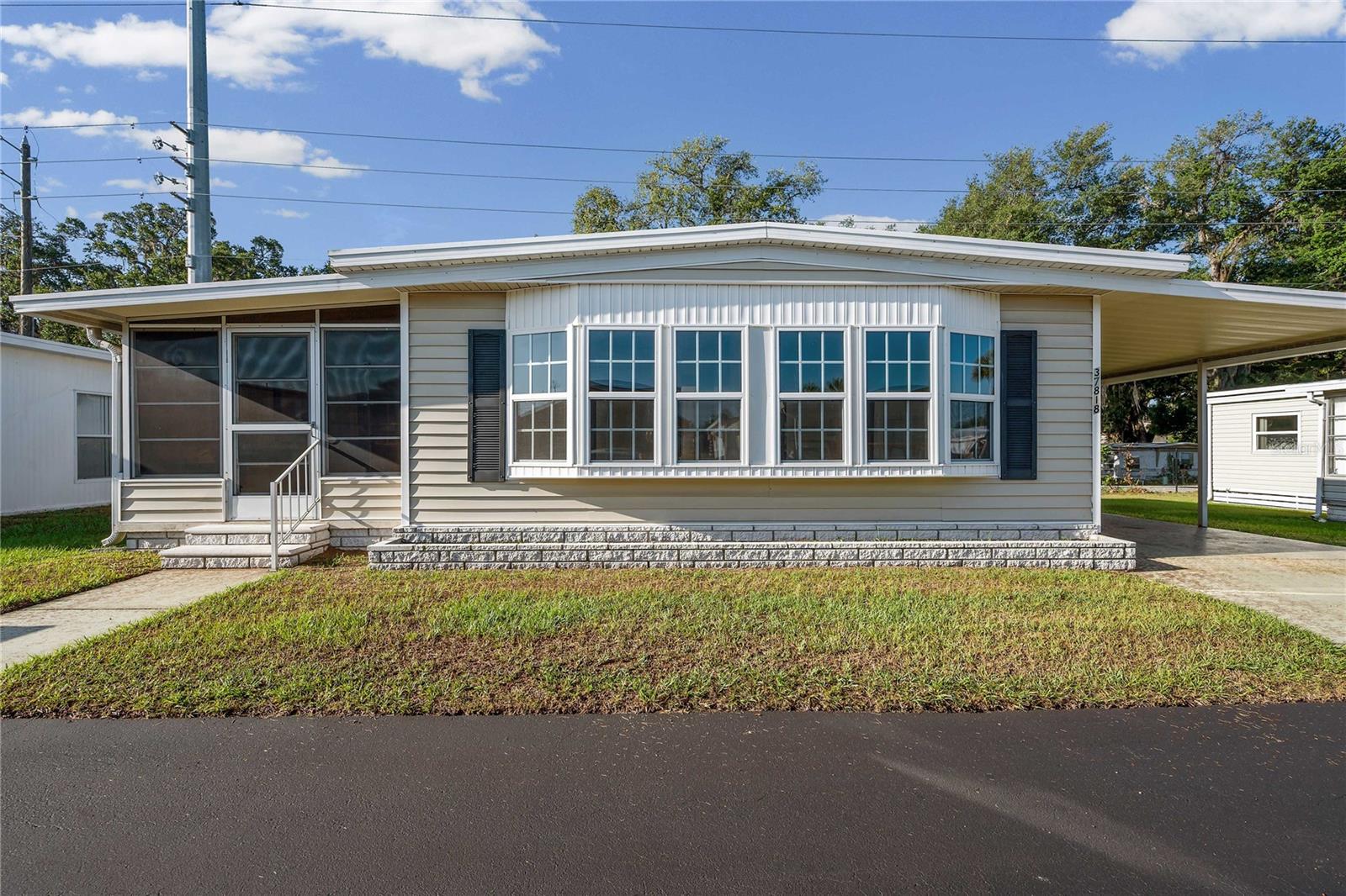Welcome to Spanish Trails Senior Village, a sought-after 55+ community where pride of ownership truly shines. This lovingly maintained 2-bedroom, 2-bath manufactured home offers numerous recent updates, including updated vinyl flooring, a new kitchen sink, a new step-in shower and vanity in the primary bathroom, and some newer double-pane windows. With thoughtful improvements throughout and exceptional attention to detail, this well-maintained home is truly move-in ready. Enjoy peace of mind with a durable metal roof and low-maintenance vinyl siding. Step inside to a comfortable and functional layout designed for easy Florida living. The bright Florida room, located at the front of the home and accessed through sliding glass doors from the living room, provides the perfect space to relax, entertain guests, or enjoy your morning coffee with a good book. The spacious primary bedroom features a walk-in closet and a private en suite bath complete with the newly updated step-in shower and vanity. Bedroom two also includes a walk-in closet and is conveniently located near the guest bathroom, which offers a tub/shower combination and linen storage. Additional conveniences include a laundry area located in the attached storage shed at the front of the carport, complete with washer, dryer, and ample shelving for all your storage needs. Residents of Spanish Trails Senior Village enjoy a vibrant and active lifestyle with convenient access to top-rated medical facilities, shopping, dining, and the beautiful Gulf Coast beaches just a short drive away. Whether you’re searching for a full-time residence or a seasonal retreat, this home offers comfort, value, and an excellent location. Schedule your private showing today and discover all that Spanish Trails living has to provide!