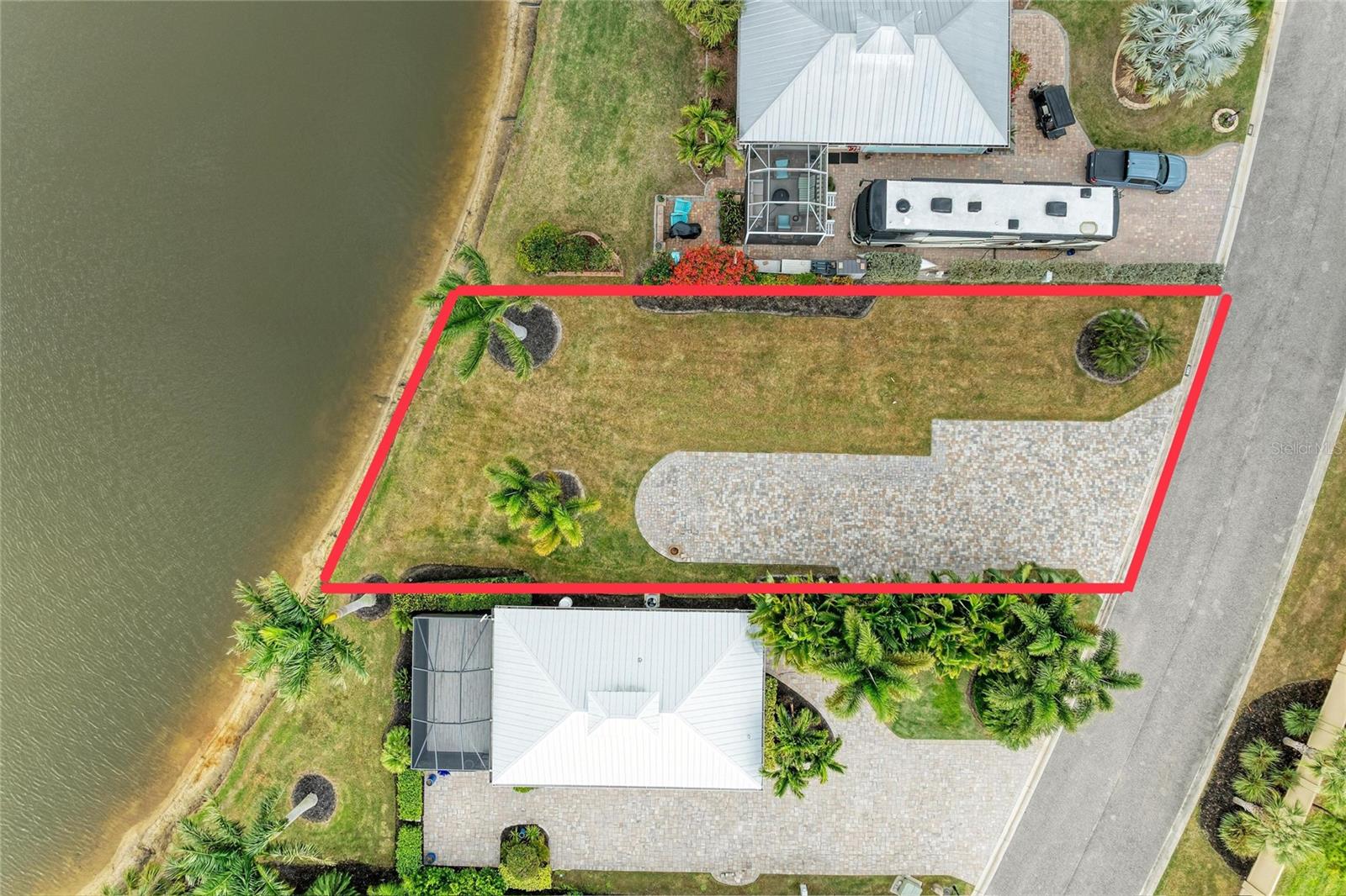 YOUR ELITE RV LOT BLANK CANVAS.
THE OPPORTUNITY YOU’VE BEEN WAITING FOR IS HERE! LOT 39 AT THORNTON CREEK MOTORCOACH RESORT. 
This is not just a lot; it’s your exclusive blank canvas to create the luxury coach-house base you’ve always dreamed of at Thornton Creek.
 Why this lot is Premium: Center View: Enjoy a clear, relaxing view of the lake and its central fountain, Class A Space: Features an oversized motorhome pad designed specifically for your Class A motorcoach, Natural Privacy; Surrounded by an elegant wall of palms that guarantees independence and tranquility, exotic Landscape; Accented with beautiful palm trees that add a tropical touch.
The Value of Undeveloped Land; This is one of the few remaining undeveloped lots in the resort. This means you can design and build your Key West style coach house with the exact distribution you desire.
Stop searching. It’s time to build.