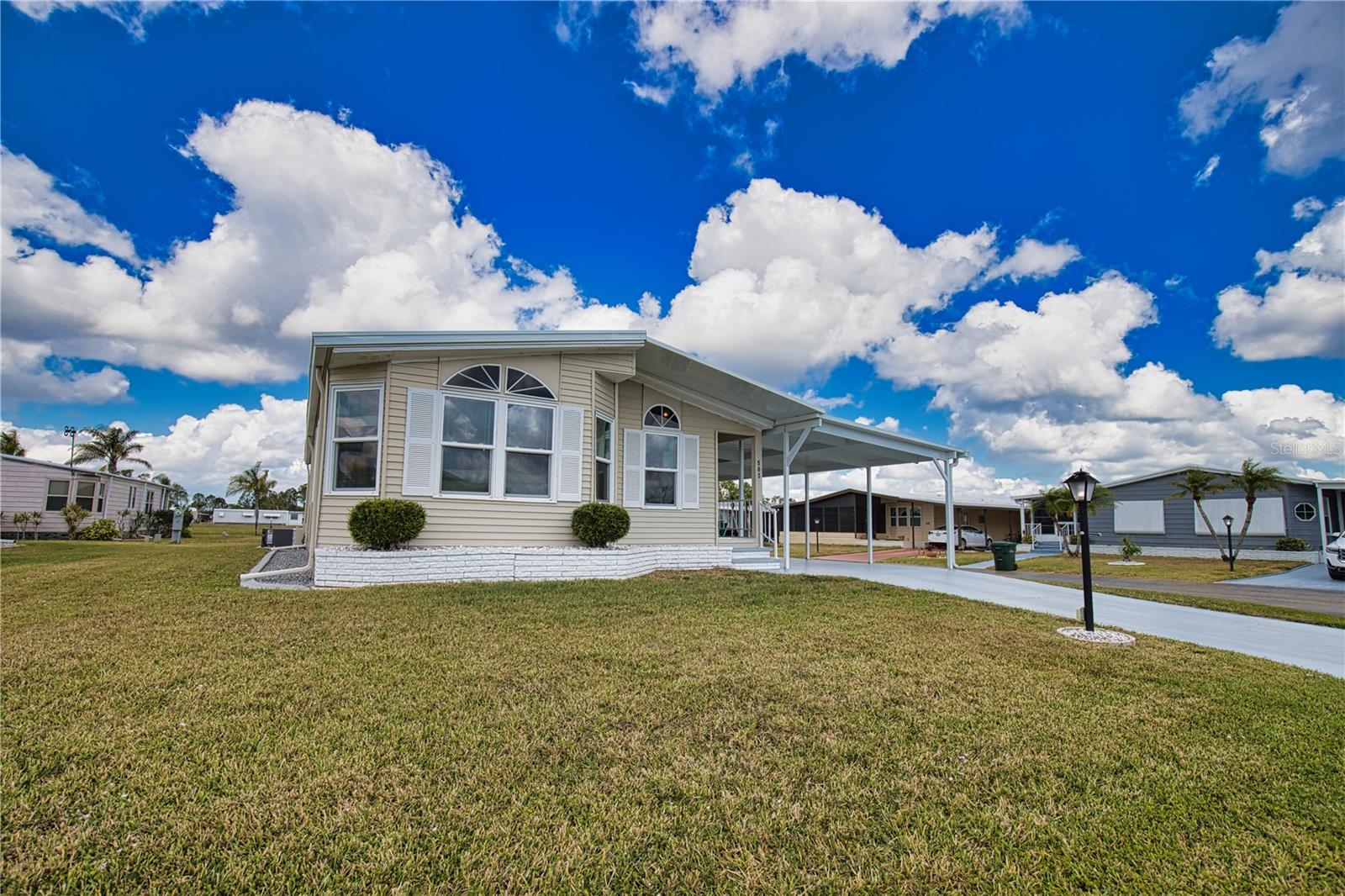 Discover the essence of Florida living in this captivating home! Tucked away on a serene street in a vibrant 55+ community, this is your golden opportunity to embrace the Florida dream. As you step inside, you'll be welcomed by a spacious living and dining room combination, bathed in natural light thanks to an abundance of windows that create a warm and inviting atmosphere. Flowing seamlessly from the dining room, the sizable kitchen beckons you to create culinary delights, while the charming breakfast nook—complete with a built-in desk—provides an ideal space for your home office needs. Retreat to the generous primary bedroom, featuring double closets and a beautiful ensuite bathroom with double sinks, plenty of cabinets, and a luxurious walk-in shower, ensuring your comfort and relaxation. Your guests will feel right at home in the cozy second bedroom, conveniently located near an additional bathroom just down the hall. For added convenience, a dedicated laundry room enhances everyday living, leading you to a delightful bonus room. This sunlit space, surrounded by windows, is perfect for entertaining friends and family or unwinding with your favorite show. Recent updates amplify this home’s appeal, featuring a brand-new shingle roof (2024), a modern A/C unit (2023), sparkling new windows (2023), and a freshly constructed lanai,
shed, and carport (2023). Don’t miss your chance to call this enchanting property your own. Golf Cart available for a separate purchase.   The Community of La Casa, where 974 stunning homes are elegantly nestled among a tapestry of native trees, offering a serene escape surrounded by spacious common areas and eight picturesque lakes. Our generous lots average an impressive 60 by 80 feet, providing ample space for your dream home. Perfectly situated between Sarasota and Fort Myers, La Casa embodies the ultimate lifestyle on Florida’s Gulf Coast—a true boaters paradise with direct access to the breathtaking Gulf of Mexico. Enjoy the convenience of nearby shopping, exciting sightseeing, world-class golfing, and abundant fishing and boating opportunities, all while indulging in the rich culture and refined elegance that Southwest Florida is celebrated for. As you immerse yourself in the warmth of Southwest Florida’s winters, you’ll find yourself in a relaxed and unhurried atmosphere, far removed from the hustle and bustle of the east coast. Our community is adorned with lush, mature landscaping that reflects the loving care both residents and management dedicate to preserving its beauty. At La Casa, you’ll discover some of the finest pools in the area. Our crowning jewel is a magnificent 40 by 60-foot swimming pool, maintained at a perfectly inviting 87 degrees. Just a short stroll away, you’ll find our cozy 20 by 40-foot pool, nestled charmingly between the clubhouse and the Activity Building. Both pools feature adjacent hot tubs, ideal for unwinding after a refreshing day of golf or an invigorating game of tennis. Stay connected while basking in the sun with our complimentary wireless Internet (Wi-Fi), available at the Clubhouse, Activity Building, and Recreation Hall. Whether you’re catching some rays or catching up on emails, La Casa has it all. Does this sound appealing? La Casa is not just a community; it’s a welcoming family-friendly haven.