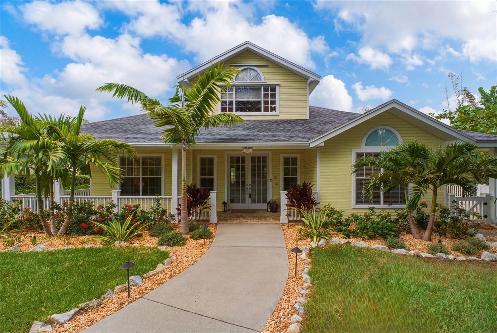 Experience the best of Florida coastal living in this exceptional custom Key West-style pool home, ideally situated on a quiet cul-de-sac atop one of the highest elevations in Crystal Beach and just steps from the water in a NON-FLOOD ZONE! Offering nearly 3,000 square feet of thoughtfully designed living space, this freshly painted interior residence features three spacious en-suite bedrooms, three full bathrooms, and a versatile loft, all within a desirable three-way split floor plan that perfectly balances openness with privacy. A welcoming glass French-door entry opens to soaring cathedral ceilings, oversized windows that fill the home with natural light, and a stunning floor-to-ceiling double-sided wood-burning fireplace that serves as the centerpiece of both the formal living room and family room. A striking spiral staircase leads to the expansive loft, offering endless flexibility as a home office, media room, library, studio, or bonus retreat. Designed to embrace Florida's indoor-outdoor lifestyle, French doors from the main living spaces open to an expansive wraparound paver porch and oversized pool deck, creating the perfect setting for effortless entertaining and everyday relaxation. At the heart of the home, the chef's kitchen showcases solid wood shaker cabinetry, granite countertops, a large center island with a prep sink and seating for up to eight, a new 2024 oven and microwave combination, a flat-top range, and an oversized walk-in pantry, all flowing seamlessly into the generous dining area. The private primary suite overlooks the sparkling pool and lush new tropical landscaping and features direct pool access, a spacious walk-in closet, quartz dual vanities, an oversized garden tub, and an updated glass-enclosed walk-in shower. Two additional oversized en-suite bedrooms, each with a walk-in closet, provide exceptional comfort and privacy for family and guests. Set on nearly half an acre, the backyard is a private tropical retreat enhanced by new landscaping, landscape lighting, a resurfaced lap pool completed in 2022, and a brand-new pool pump installed in 2025. Significant improvements—including a NEW 2025 ROOF, NEW 2023 water heater, and a recently passed transferable four-point inspection—offer exceptional peace of mind. The oversized rear-entry two-car garage, accessed from Seaford Avenue, provides ample storage, while the absence of deed restrictions allows you to keep your boat, RV, or other recreational vehicles at home. With the public Sutherland Bayou boat ramp just minutes away, adventures on the Gulf are always within easy reach. Located in the charming, golf cart-friendly community of Crystal Beach, residents enjoy direct access to the Pinellas Trail, spectacular sunsets at Live Oak Park, top-rated Palm Harbor University High School, and a relaxed coastal lifestyle that is second to none. Combining timeless Key West architecture, quality updates, exceptional privacy, and an unbeatable location, this remarkable home presents a rare opportunity to own one of Crystal Beach's premier coastal retreats. Don't wait - CALL TODAY FOR YOUR PRIVATE SHOWING!