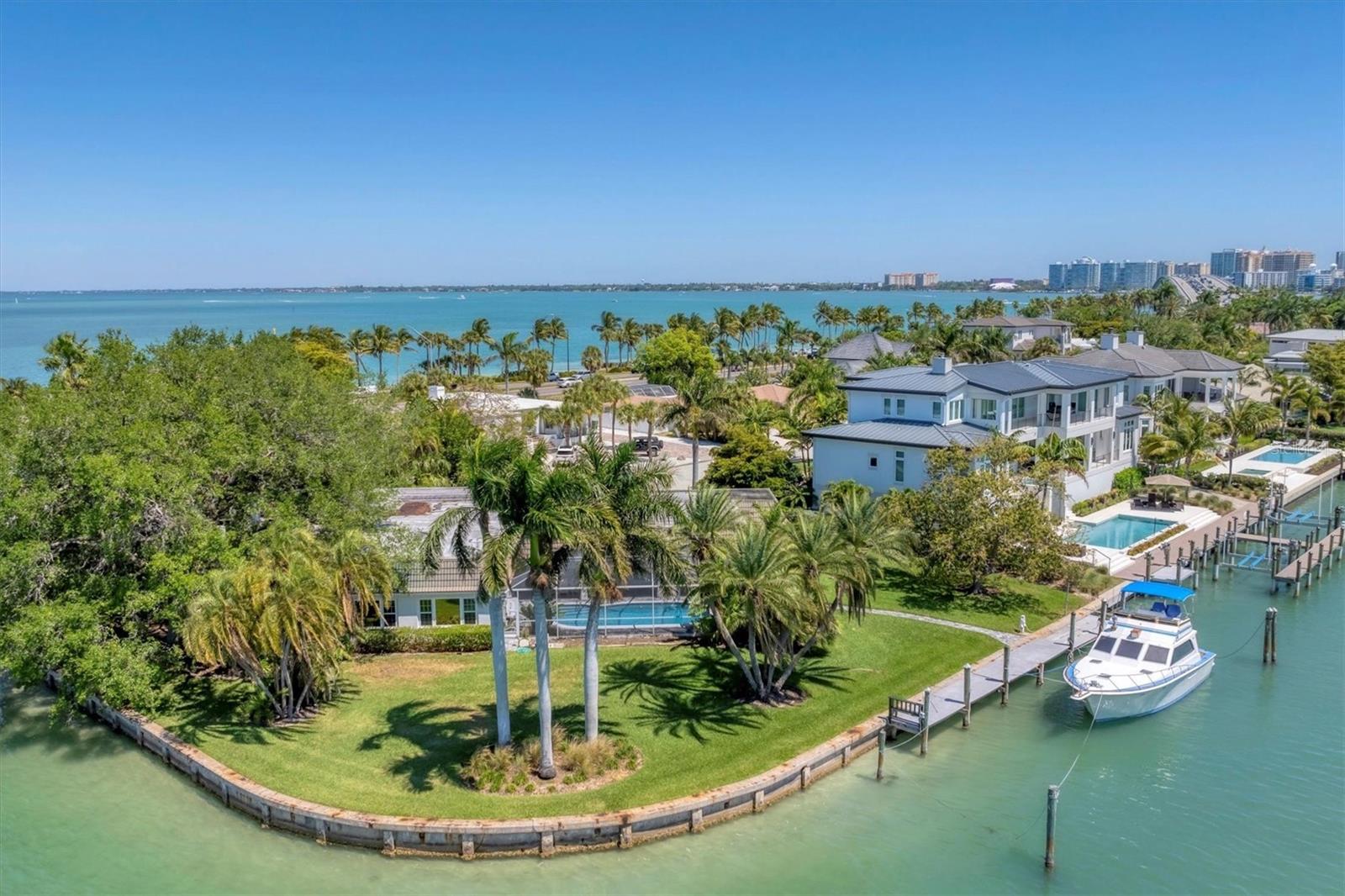 Incredible boating water! Move in, remodel, or build your dream home on this exceptional half-acre corner lot with unobstructed bay views. This stunning property is perfect for the boating enthusiast with deep water access, an impressive 275 feet of seawall, and a unique lot configuration that can accommodate a yacht of up to 80 feet without compromising the views. Situated on Bird Key, this location offers convenient access to St. Armands Circle, Lido Key, Longboat Key, and the many cultural and dining attractions of downtown Sarasota. Bird Key HOA features a social club with dining, pool, tennis courts, fitness center, marina, and more. ***This home did not experience any water intrusion from the 2024 hurricanes.