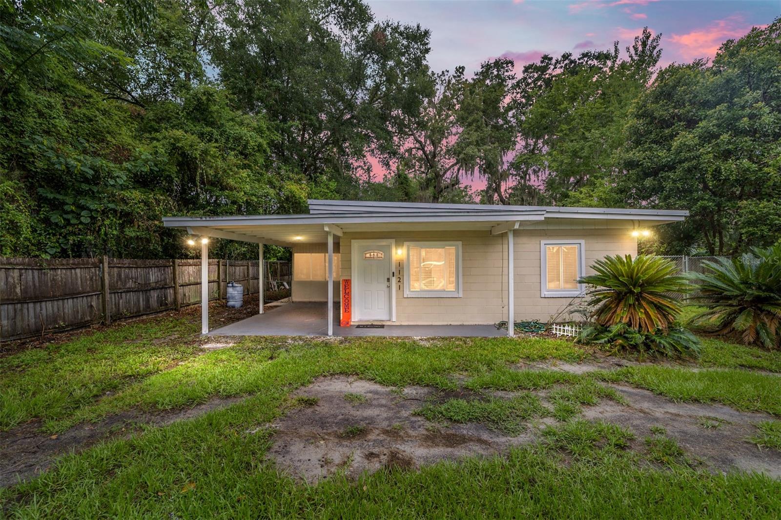 The interior of this 2 bedroom 1 bath home has been fully renovated and now features new metal roof replaced in 2020, new  windows, doors, tile, and plumbing. The kitchen has been upgraded with brand new cabinets, stainless steel appliances, a large stainless apron sink, and a spacious granite counter top/bar. Other upgrades include a new instant hot water heater, AC, travertine-tiled shower with mosaic tile accents, light fixtures/fans, baseboard, crown, and trim. Home is an operating AIRBNB and would a perfect TURNKEY investment property or primary residence as the furniture will convey with sale. The interior and exterior have been freshly painted,  This home is in a prime location, just steps away from the new Lucky's Supermarket, restaurants and 4 min drive to UF.