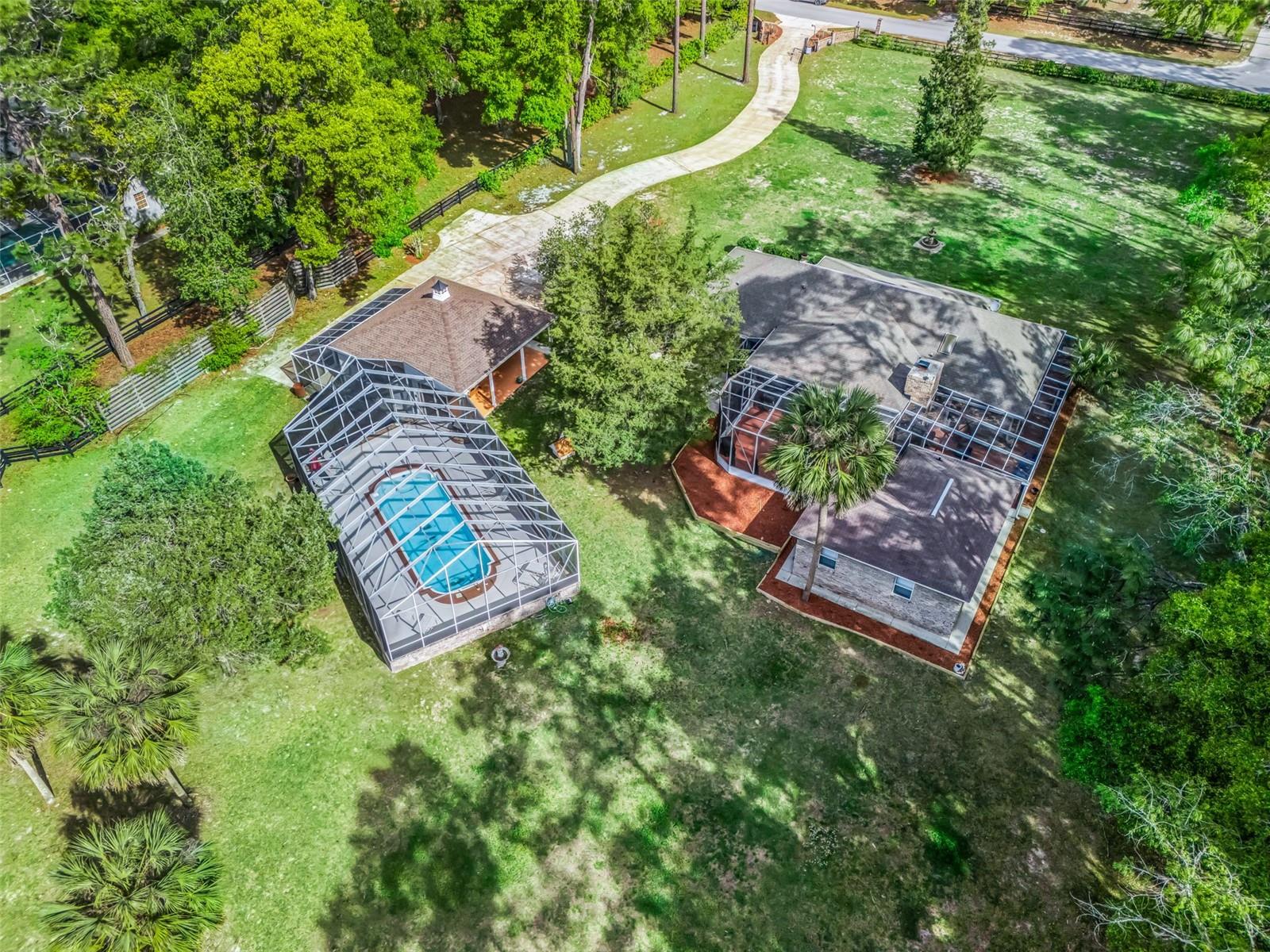 3,141 sq. Ft. Custom built brick pool home on 3 acres located just down the street from the World Equestrian Center Ocala! The property boasts an updated main house with 5 bedrooms, detached guest casita with 1 bedroom & full bathroom, detached 4-car garage & screened-in pool. The private gated entrance leads to the main house & garage with plenty of parking & a large concrete pad for an RV, horse trailer or boat. There is no HOA & the 3 acres is fully fenced & ready for a horse barn to be built. The house has 2 primary suites both with ensuite full baths, 3 additional bedrooms, living room, dining room, & cozy family room with fireplace leading to the huge screened- in lanai. The kitchen has been updated with granite counter tops & stainless appliances plus the internal laundry room is over-sized with sink & shower. Throughout the house & casita you will find all wood laminate & tile flooring. The detached guest casita has a separate entrance with living room, bedroom & full bathroom. There is also a generator including in-ground propane tank. Well located within a quiet equestrian community, this property is move-in ready!